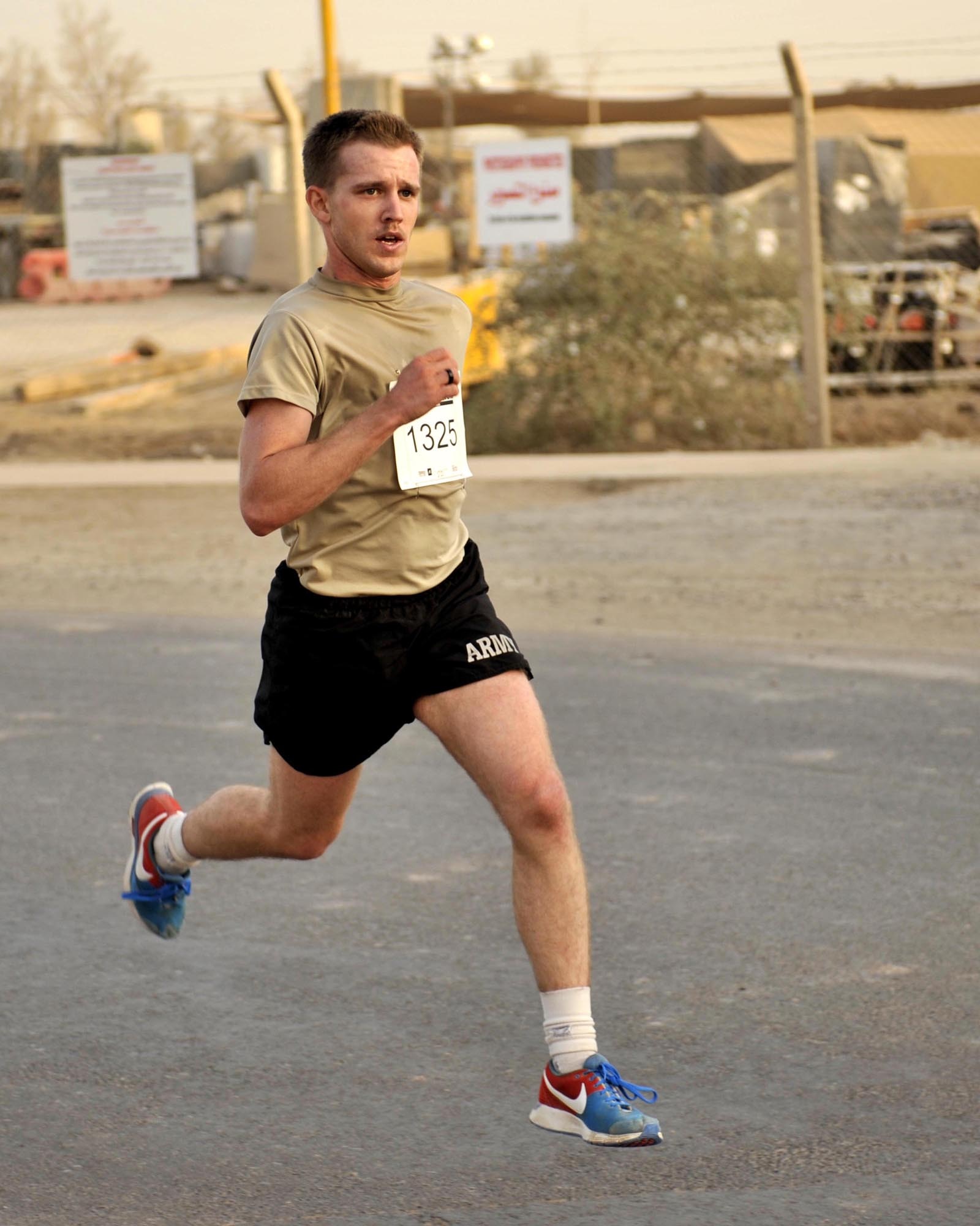 9/20/2008 ? SATHER AIR BASE, Iraq ? Christopher Haag sprints towards the finish line at the 10 K run hosted in Baghdad as part of the 12th Annual Air Force Marathon. Haag finished the run with a first-place time of 36:47. More than 300 Airmen, Soldiers, Marines, Sailors, Defense Department civilians, contractors and coalition military members came out to participate in the run on dirt roads along the flightline west of Baghdad International Airport. The 26.2-mile Air Force Marathon, hosted at Wright-Patterson Air Force Base, Ohio, kicked off with a fly-over by a formation of an F-16 Fighting Falcon, F-15 Strike Eagle and F-22 Raptor. The Baghdad runners also had a flyover of sorts, as a C-17 Globemaster III and C-130 Hercules, as well as HH-60 Blackhawk helicopters all took off from Sather AB during the run in support airlift missions in and around the Operation Iraqi Freedom theater of operations.   (U.S. Air Force photo by Master Sgt. Brian Davidson)