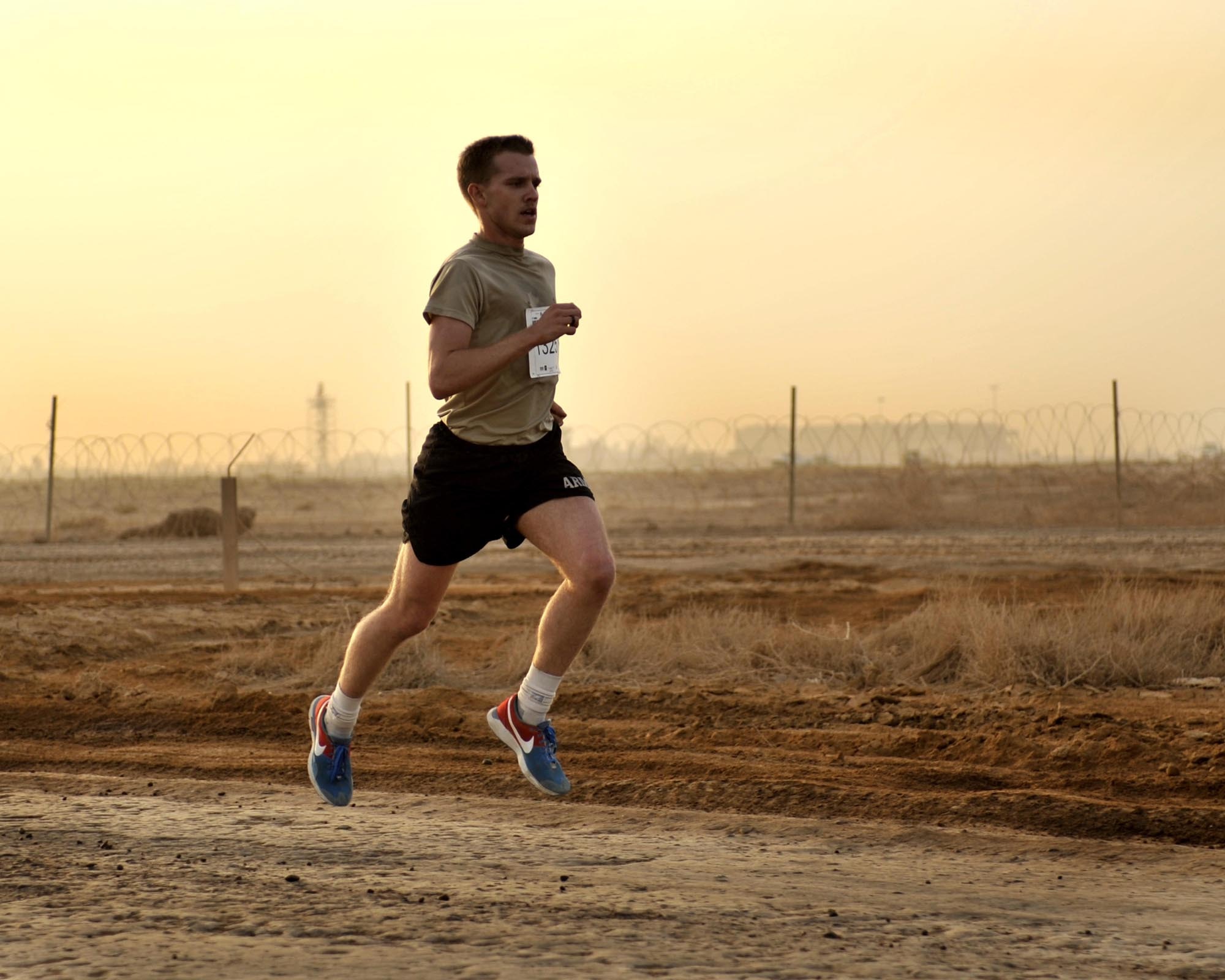 9/20/2008 ? SATHER AIR BASE, Iraq ? Christopher Haag passes the half-way point as he pulls away from more than 300 other runners at the 10 K run hosted in Baghdad as part of the 12th Annual Air Force Marathon. Haag finished the run with a first-place time of 36:47. Airmen, Soldiers, Marines, Sailors, Defense Department civilians, contractors and coalition military members came out to participate in the run on dirt roads along the flightline west of Baghdad International Airport. The 26.2-mile Air Force Marathon, hosted at Wright-Patterson Air Force Base, Ohio, kicked off with a fly-over by a formation of an F-16 Fighting Falcon, F-15 Strike Eagle and F-22 Raptor. The Baghdad runners also had a flyover of sorts, as a C-17 Globemaster III and C-130 Hercules, as well as HH-60 Blackhawk helicopters all took off from Sather AB during the run in support airlift missions in and around the Operation Iraqi Freedom theater of operations.   (U.S. Air Force photo by Master Sgt. Brian Davidson)