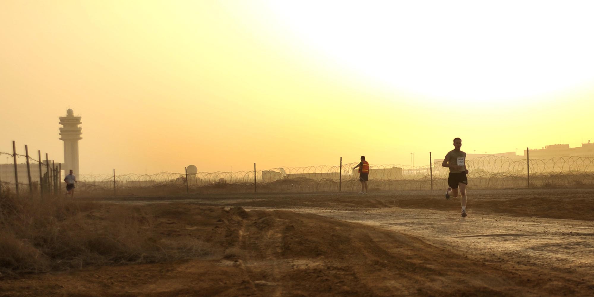 9/20/2008 ? SATHER AIR BASE, Iraq ? Christopher Haag passes the half-way point as he pulls away from more than 300 other runners at the 10 K run hosted in Baghdad as part of the 12th Annual Air Force Marathon. Haag finished the run with a first-place time of 36:47. Airmen, Soldiers, Marines, Sailors, Defense Department civilians, contractors and coalition military members came out to participate in the run on dirt roads along the flightline west of Baghdad International Airport. The 26.2-mile Air Force Marathon, hosted at Wright-Patterson Air Force Base, Ohio, kicked off with a fly-over by a formation of an F-16 Fighting Falcon, F-15 Strike Eagle and F-22 Raptor. The Baghdad runners also had a flyover of sorts, as a C-17 Globemaster III and C-130 Hercules, as well as HH-60 Blackhawk helicopters all took off from Sather AB during the run in support airlift missions in and around the Operation Iraqi Freedom theater of operations.   (U.S. Air Force photo by Master Sgt. Brian Davidson)
