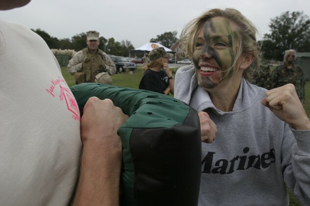 A Marine spouse punches a martial arts pad during the U.S. Marine Corps Forces, Special Operations Command, Marine Special Operations Support Group Jane Wayne Day in front of the Goettge Field House here, Sept. 24.