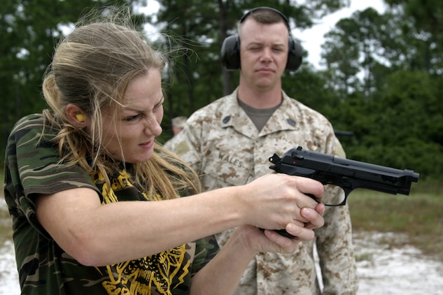 A Marine spouse shoots a target with an M9 9mm pistol during the U.S. Marine Corps Forces, Special Operations Command, Marine Special Operations Support Group Jane Wayne Day at Range F4 here, Sept. 24.