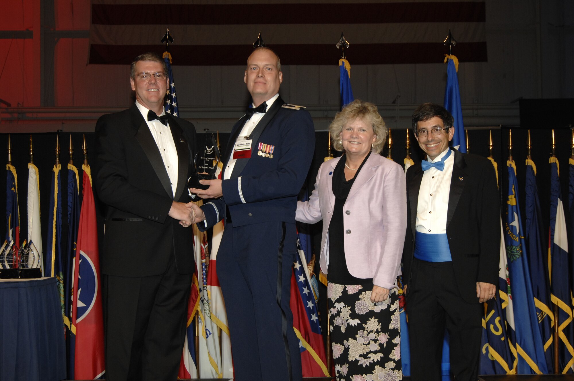 Terry Jaggers, Deputy Assistant Secretary of the Air Force for Science, Technology and Engineering, presents the Air Force Research and Development Award to Major Greg Meyer along with Mrs. Sue Payton, Under Secretary of the Air Force for Acquisition, and Dr. Mark Lewis, Chief Scientist of the Air Force. (courtesy photo)