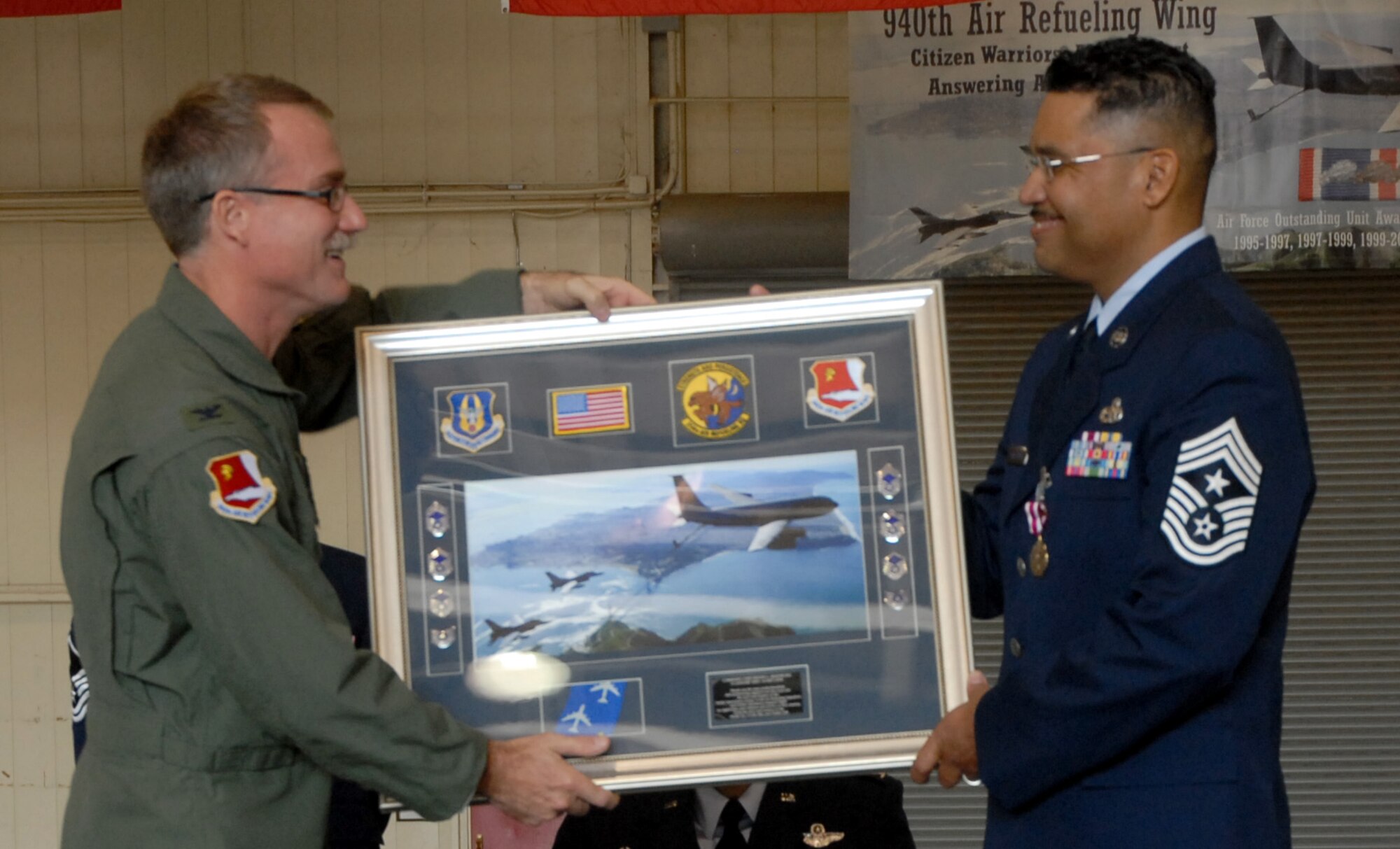 BEALE AIR FORCE BASE, Calif. -- Retiring 940th Air Refueling Wing Command Chief Master Sgt., Anthony Armstrong, and Col. David Goodhue, 940th Operations Group commander, share a laugh Sept. 14, 2008, during formal gift presentations at the Chief's ceremony. The retirement ceremony was followed by the installation of the next CCM, CMSgt. (sel) Jason Henderson. (U.S. Air Force photo/Staff Sgt. Luke D. Johnson)