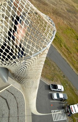FAIRCHILD AIR FORCE BASE, Wash. – Staff Sgt. Julie Chilton, 92nd Operations Support Squadron, slides down the life chute Sept. 24. This training is done annually to practice egress procedures from Fairchild’s Air Traffic Control Tower. (U.S. Air Force photo / Staff Sgt. JT May III)

