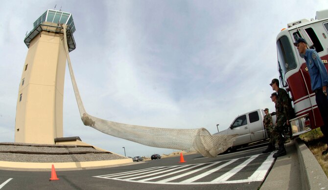 FAIRCHILD AIR FORCE BASE, Wash. – The 92nd Operations Support Squadron practiced egress procedures from Fairchild’s Air Traffic Control Tower Sept. 24 using the 112-foot long Baker Life Chute. The chute is used to quickly and safely evacuate Airmen from the six-story tower. Airmen must keep their bodies straight and their hands above their heads to safely take the plunge. Airmen can also control the speed of their descent with their legs. (U.S. Air Force photo / Staff Sgt. JT May III)
