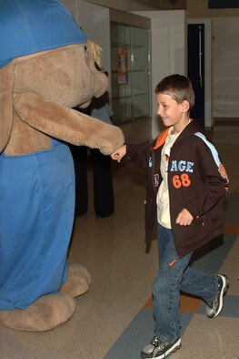 FAIRCHILD AIR FORCE BASE, Wash. – Maxim Ward, fourth grader at Michael Anderson Elementary School, gives knuckles to Sammy Rabbit after an entertaining and educational performance at Michael Anderson Sept. 23. “From every dollar save a dime,” was one of Sammy Rabbit’s main messages expressed to more than 300 students at the school. (U.S. Air Force photo / Senior Airman Jocelyn A. Ford)
