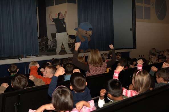 FAIRCHILD AIR FORCE BASE, Wash. – Maxim Ward, fourth grader at Michael Anderson Elementary School, gives knuckles to Sammy Rabbit after an entertaining and educational performance at Michael Anderson Sept. 23. “From every dollar save a dime,” was one of Sammy Rabbit’s main messages expressed to more than 300 students at the school. (U.S. Air Force photo / Senior Airman Jocelyn A. Ford