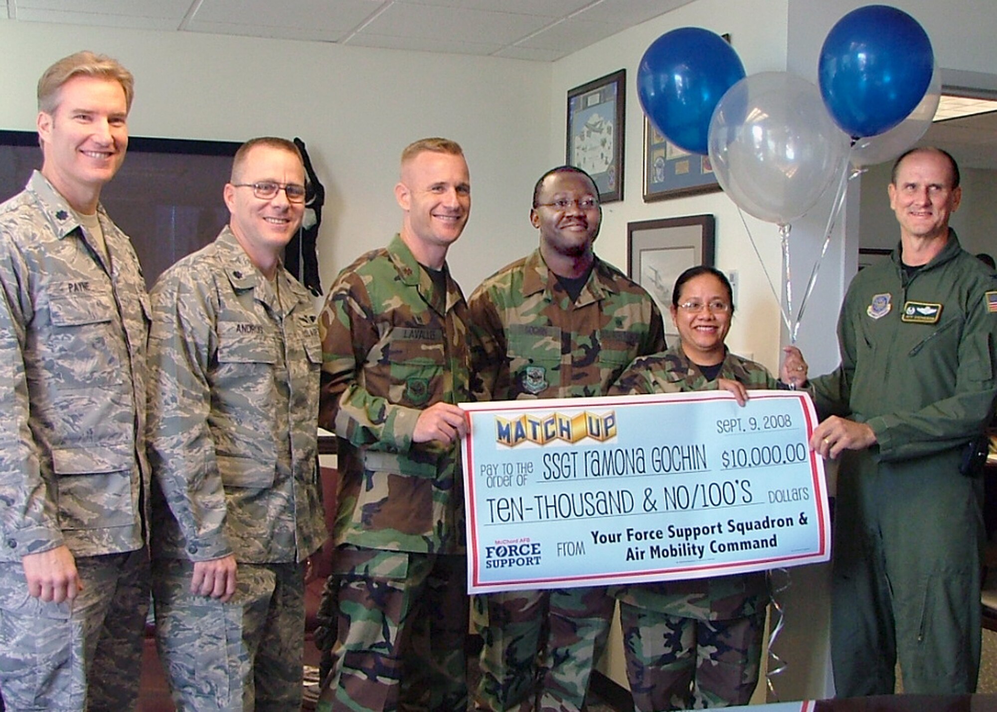 MCCHORD AIR FORCE BASE, Wash. – Members from the 62nd Airlift Wing crowd around Staff Sgt. Ramona Gochin, grand prize winner for the AMC MatchUP game that ended Aug. 31. Sergeant Gochin won $10,000. The other two winners, Austin Moore, son of Maj. Robert Moore, Fairchild Air Force Base, Wash., and Airman 1st Class Matthew Park, McGuire Air Force Base, N.J., won the $7,000 and $5,000 cash prizes respectively. (U.S. Air Force courtesy photo)

