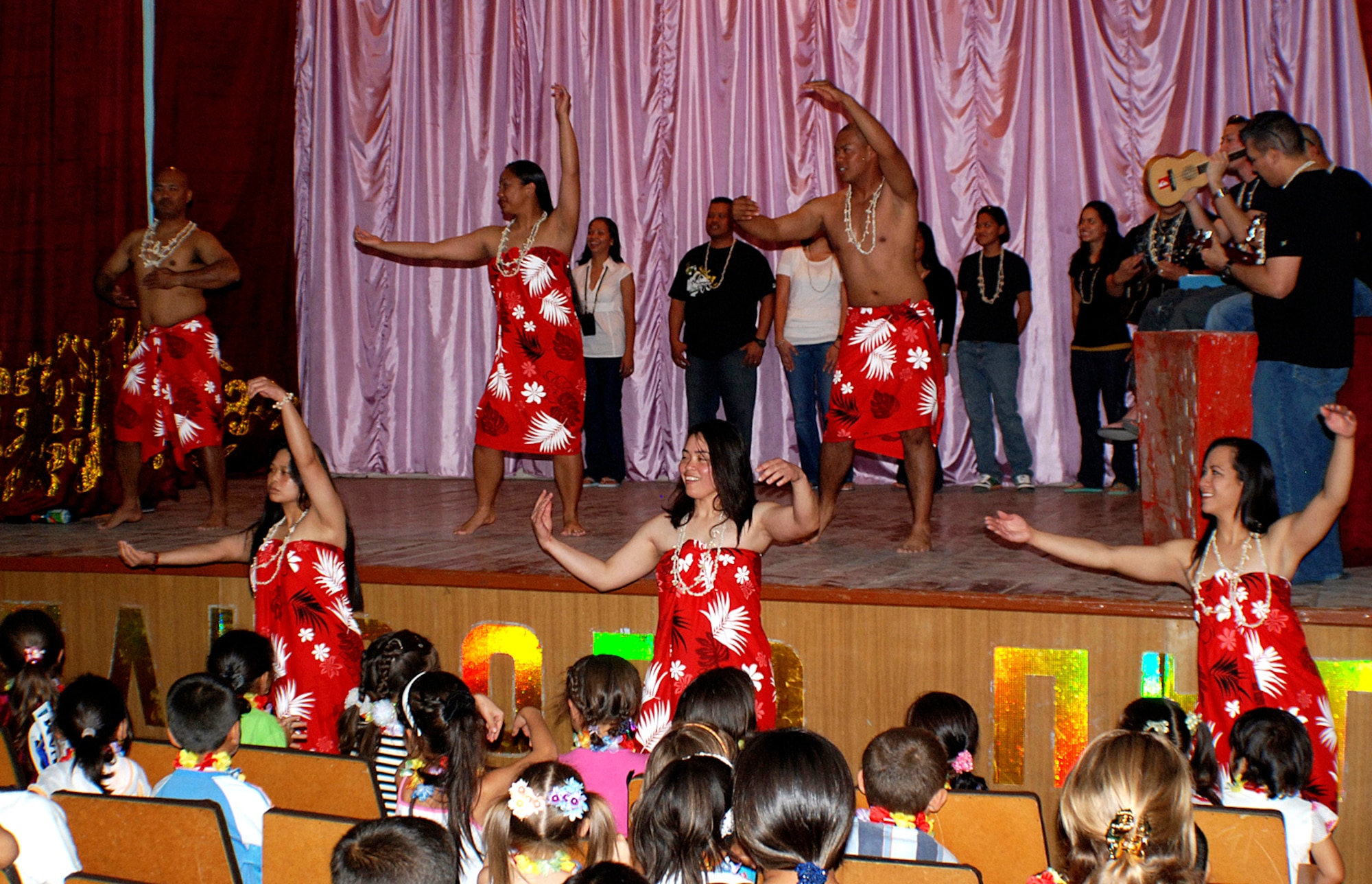 Airmen from Manas Air Base, Kyrgyz Republic, share traditional Pacific Island songs and dances with a group of more than 100 Kyrgyz children in the village of Jeny Pahkta, Aug. 20. Members of the 376th Air Expeditionary Force Support Squadron has sponsored the Kyrygz village for six years, donating clothes and painting and cleaning the local school. (U.S. Air Force photo/Senior Airman Alison Osborn)