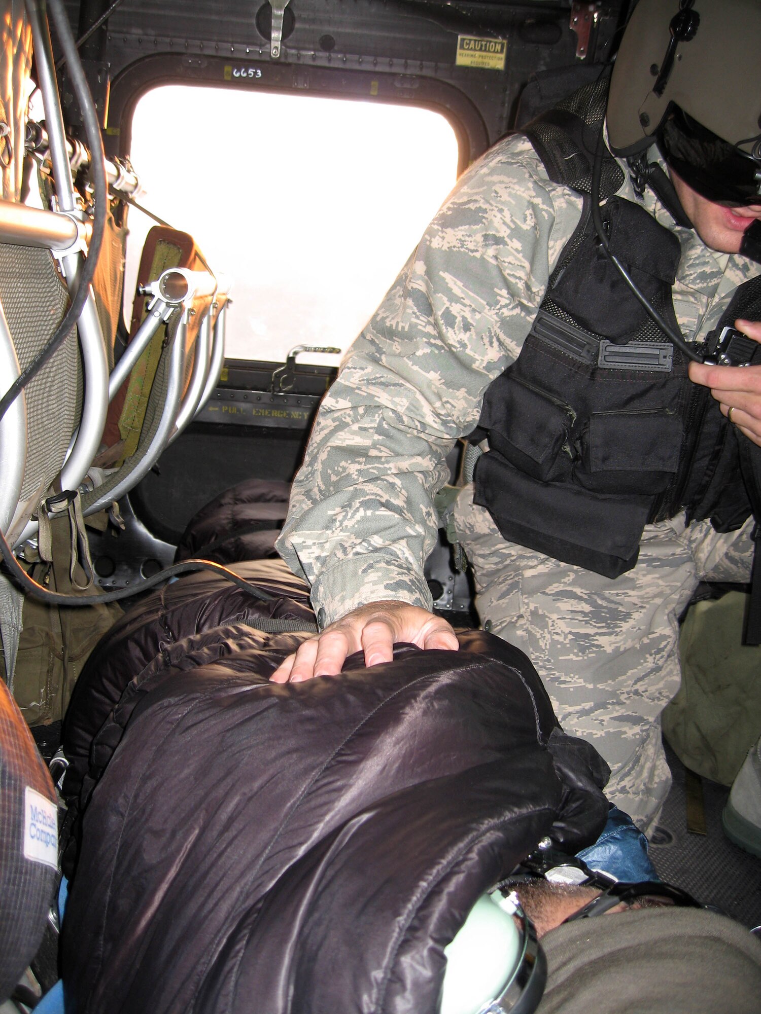 FAIRCHILD AIR FORCE BASE, Wash. – Capt. Cameron Clement, physician’s assistant with the 336th Training Support Squadron here, administers medical aid in a UH-1N Huey helicopter Sept. 18 to a 39-year-old man who had been stranded in the Cascade Mountains since Sept. 12. Captain Clement was part of a five-man team dispatched from Fairchild to evacuate the wounded man to a waiting ambulance. “We’ve got a great bunch of professionals flying here,” said Col. Scott Greene, 336th Training Support Group commander in praise of the crewmembers. “These guys performed outstandingly; I’m really proud of them.” (U.S. Air Force photo / Senior Airman Jacob Bragg)