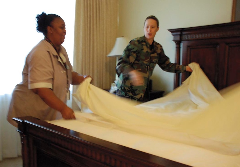Lt. Col. Teresa L. Forest, 316th Force Support Squadron commander, helps Ms. Deborah Brown, a room attendant with lodging for almost six years, make a bed in the Gateway Inn Sept. 18. Col. Forest, along with other FSS staff helped out in culmination of the week long effort to show their appreciation to lodging employees for their dedicated work. (US Air Force/A1C Patrick McKenna)