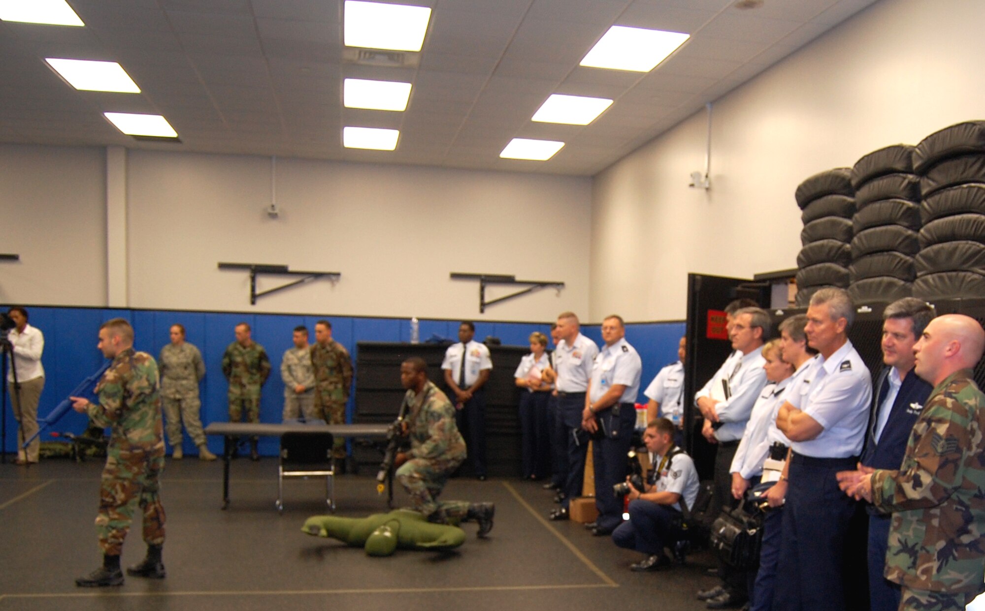 Staff Sgt. Anthony Richards (far right), from the U.S. Air Force Expeditionary Center's 421st Combat Training Squadron, shows Lt. Gen. Vern "Rusty" Findley, Air Mobility Command vice commander, how students in the Phoenix Warrior Training Course practice "tape drills" during a tour of the USAF EC for General Findley Sept. 22, 2008, on Fort Dix, N.J.  General Findley visited the USAF EC for two days to learn about the unit's mission and capabilities.  (U.S. Air Force Photo/Tech. Sgt. Scott T. Sturkol)