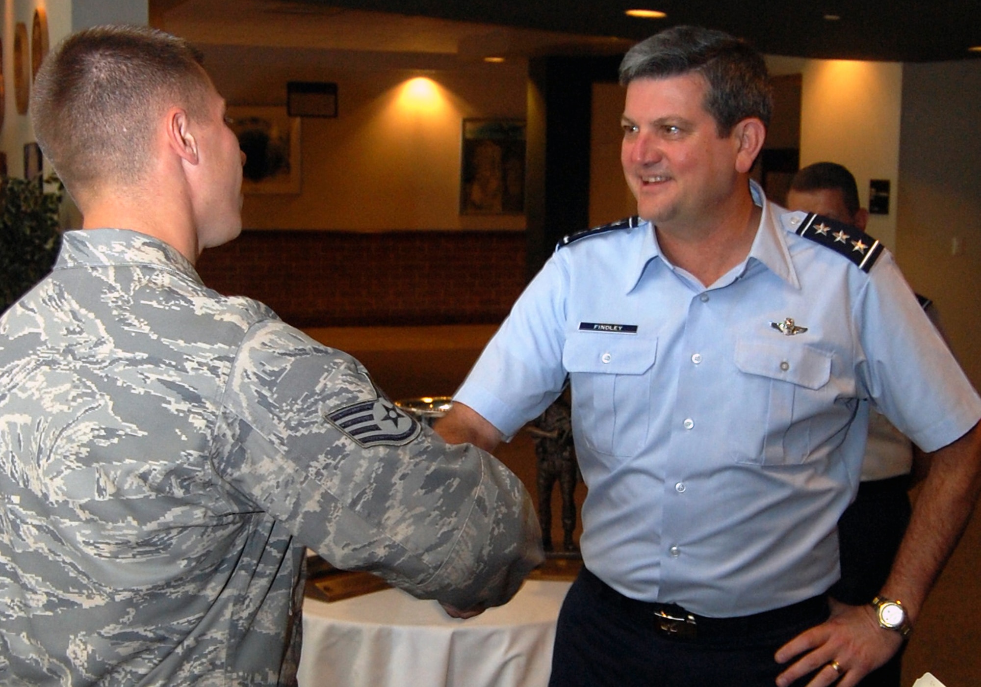 Staff Sgt. James Chubb, from the U.S. Air Force Expeditionary Center's 421st Combat Training Squadron, greets Lt. Gen. Vern "Rusty" Findley, Air Mobility Command vice commander, during a tour of the USAF EC for General Findley Sept. 22, 2008, on Fort Dix, N.J.  General Findley visited the USAF EC for two days to learn about the unit's mission and capabilities.  (U.S. Air Force Photo/Tech. Sgt. Scott T. Sturkol)