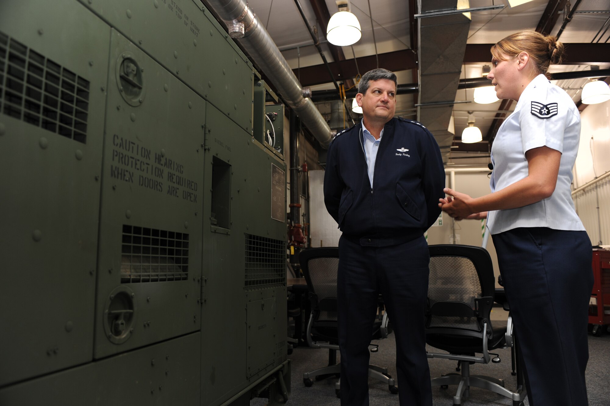 Staff Sgt. Jamie Widrig, from the U.S. Air Force Expeditionary Center's Mobility Operations School, shows Lt. Gen. Vern "Rusty" Findley, Air Mobility Command vice commander, a generator used for training in the Mobile Command and Control Generator Course during a tour of the USAF EC for General Findley Sept. 22, 2008, on Fort Dix, N.J.  General Findley visited the USAF EC for two days to learn about the unit's mission and capabilities.  (U.S. Air Force Photo/Staff Sgt. Nathan Bevier)
