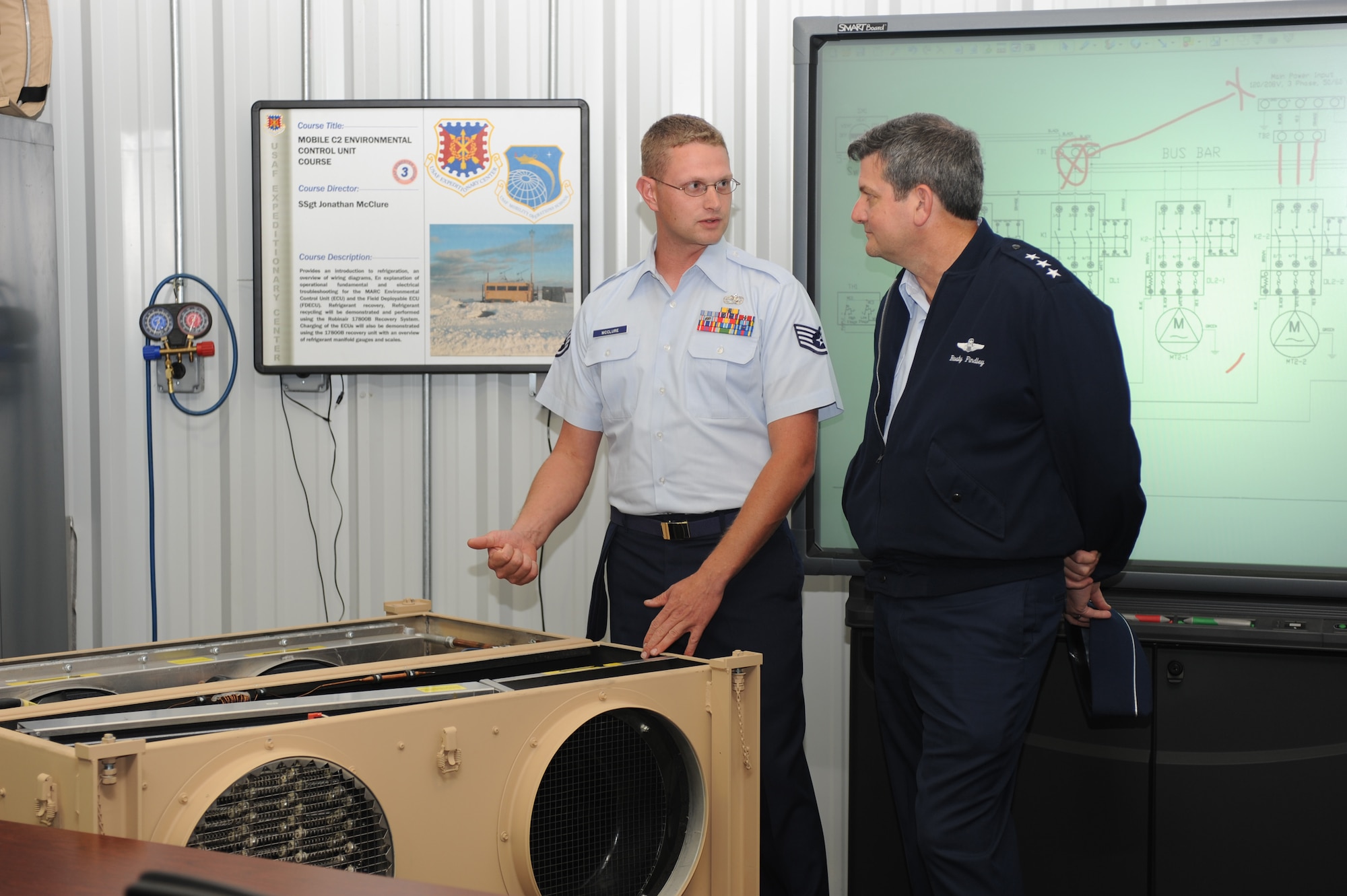 Staff Sgt. Jonathan McClure, from the U.S. Air Force Expeditionary Center's Mobility Operations School, shows Lt. Gen. Vern "Rusty" Findley, Air Mobility Command vice commander, some of equipment he uses for training in the Environmental Control Unit Course during a tour of the USAF EC for General Findley Sept. 22, 2008, on Fort Dix, N.J.  General Findley visited the USAF EC for two days to learn about the unit's mission and capabilities.  (U.S. Air Force Photo/Staff Sgt. Nathan Bevier)