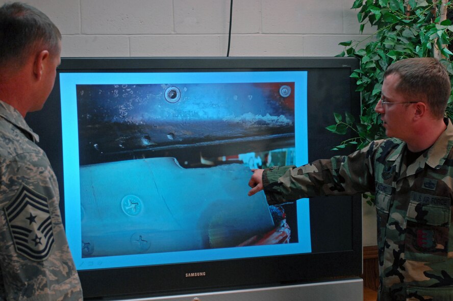 Staff Sgt. John Alford, 28th Maintenance Squadron isochronal dock chief, explains a missing part on a  B-1B Lancer from a slide show to Chief Master Sgt. Lloyd Hollen, 12th Air Force command chief, Sept. 24, 2008. Chief Hollen visited the 28th Maintenance Group as part of his two-day Ellsworth tour. (U.S. Air Force photo by Airman Corey Hook)