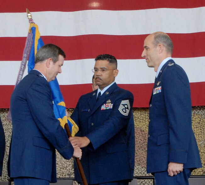 BEALE AIR FORCE BASE, Calif. -- 10th Air Force Commander, Air Force Reservist Brig. Gen. Thomas Coon, receives the 940th Air Refueling Wing flag from 940th ARW Command Chief Hilton "Anthony" Armstrong to give to Col. Jeffrey Mineo for the assumption of command of the 940th ARW  Sept. 13, 2008.  The ceremony officially ended the aerial refueling operations for the 940th ARW by deactivating the 940th Maintenance Group and 314th Air Refueling Squadron, which flew the KC-135 Stratotankers.  Col. Albert M. Reif relinquished command of the 940th ARW to Col. Jeffery T. Mineo and the wing officially transferred from the 4th Air Force to the 10th Air Force. (U.S. Air Force Photo/ Tech. Sgt Brandie Brockett)
