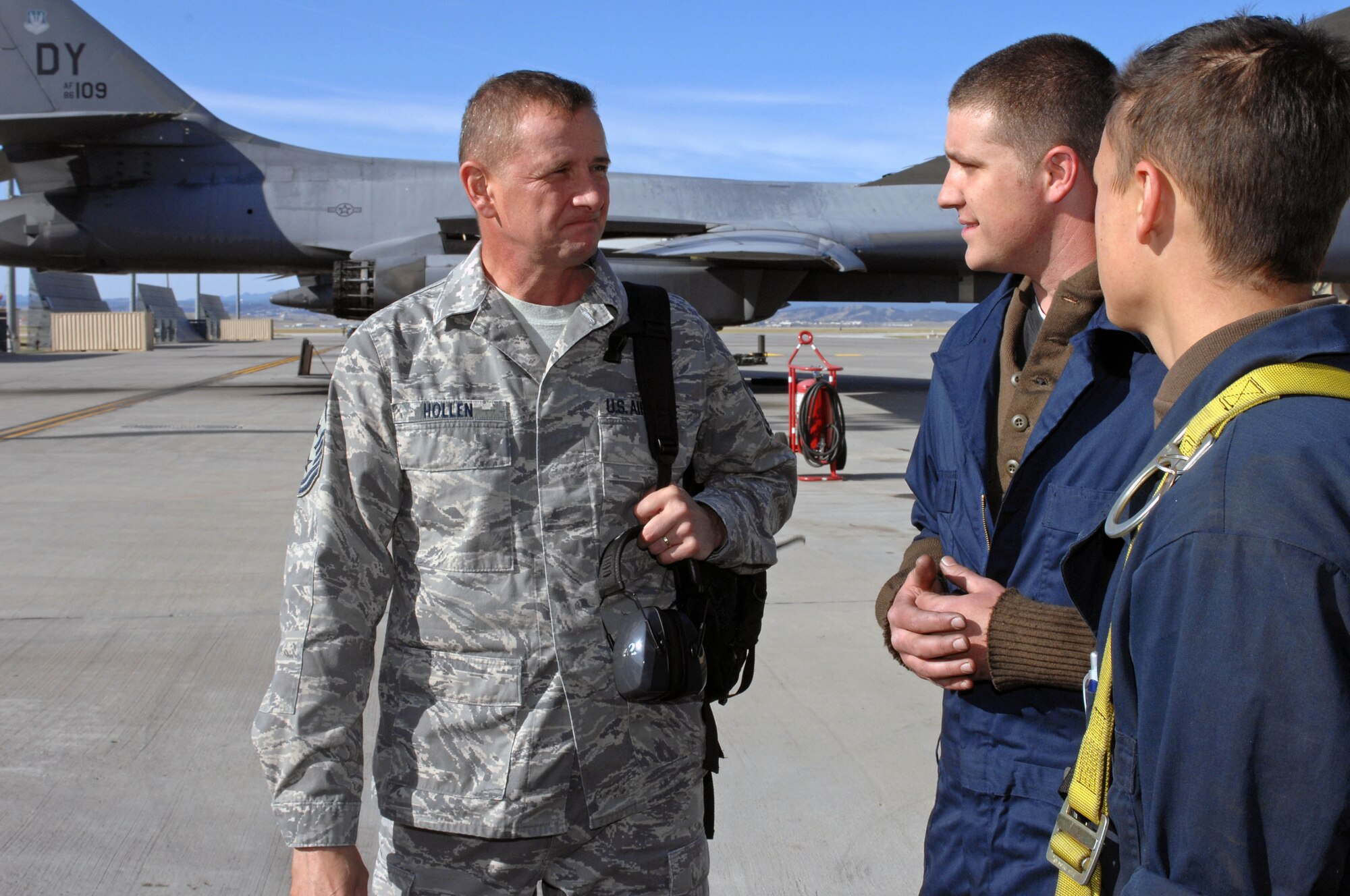 Chief Master Sgt. Lloyd Hollen, 12th Air Force command chief, speaks with Senior Airman Mark Crum and Airman 1st Class Garrett Lawrence, 28th Aircraft Maintenance Squadron electricians, Sept. 24. Chief Hollen toured different squadrons at Ellsworth to visit and speak to Airmen in various specialties. (U.S. Air Force photo by Airman Corey Hook)