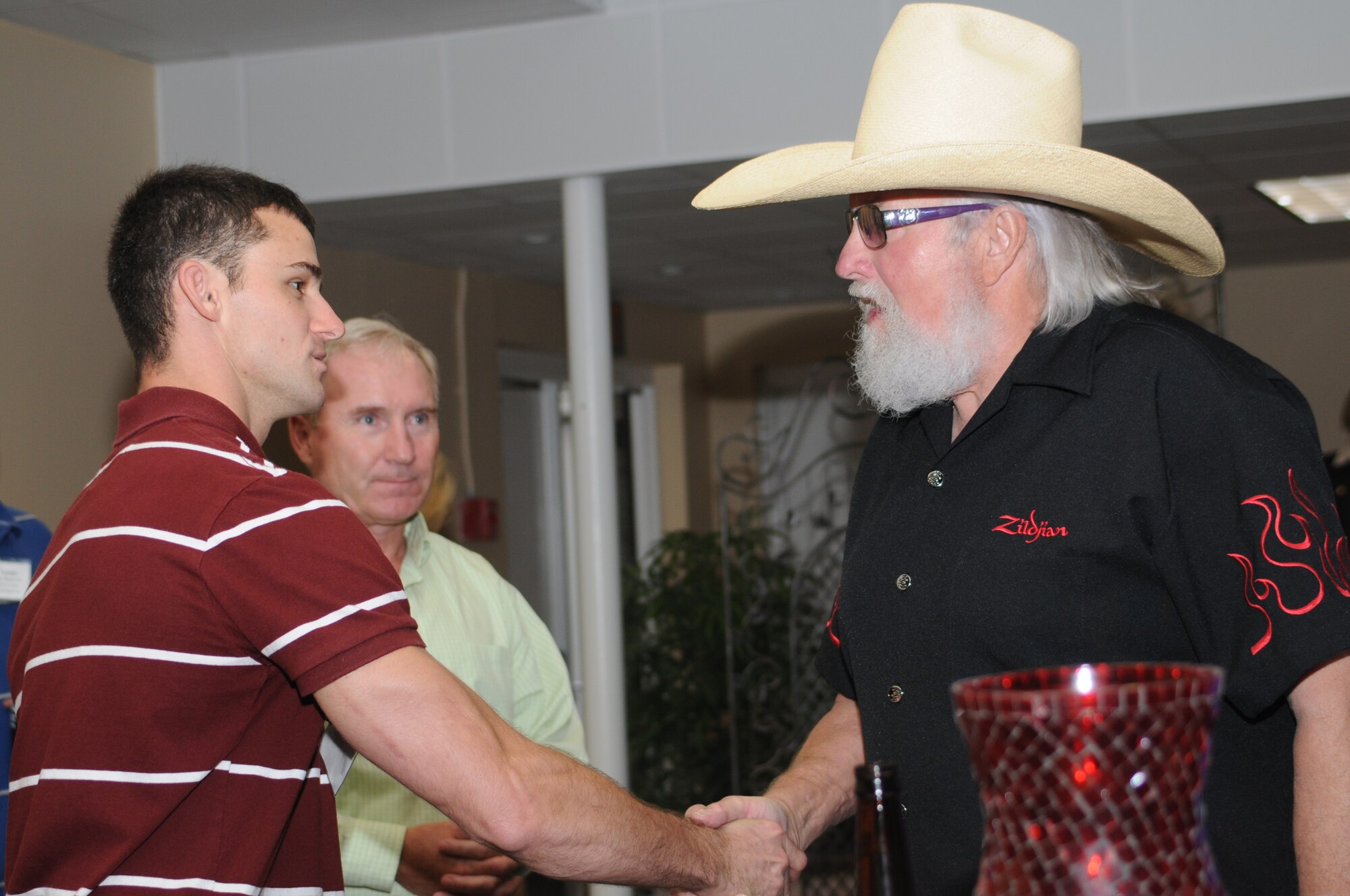 Ssgt Mike McCormick, 334th Training Squadron, shakes hands with Charlie Daniels at a pre-concert reception where Mr. Daniels met with base leadership, local community members and several Keesler Airmen who earned Bronze Stars for their actions in Iraq.  The Charlie Daniels Band performed for Keesler Air Force Base Airmen, families and local community members Sept. 18 to help celebrate the Air Force's 61st birthday.  (U.S. Air Force photo by Kemberly Groue)