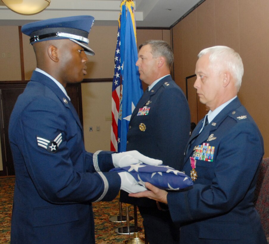 BEALE AIR FORCE BASE, Calif. -- Vice Commander of the 940th Air Refueling Wing, Air Force Reservist Col. David L. Mitchell is presented a retirement flag that flew over the U.S. capital from a member of Beale AFB honor guard during his retirement ceremony Sept. 13, 2008. All members of U.S. armed forces, which include guard and reserve, are entitled to a retirement flag. Col. Mitchell retired from the Air Force Reserves after 35 years of honorable service. He served as 940th ARW Vice Wing Commander for two years and had logged more than 8,500 flight hours in cargo and refueling aircraft. (U.S. Force Photo/ Tech. Sgt. Brandie Brockett) 