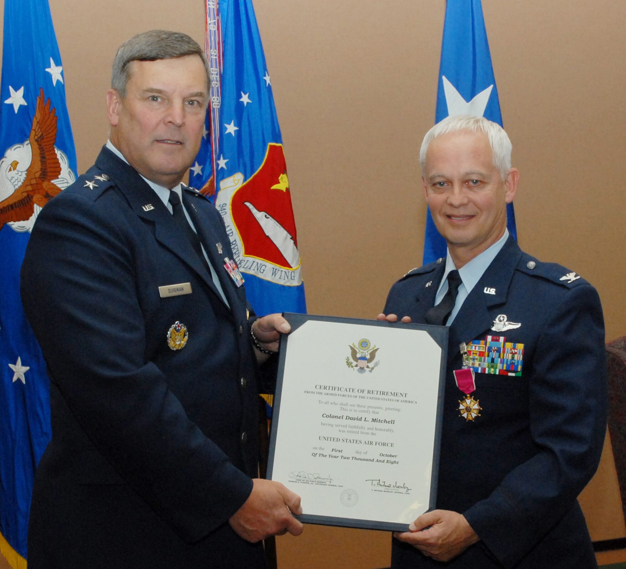 BEALE AIR FORCE BASE, Calif. -- Vice Wing Commander of the 940th Air Refueling Wing, Air Force Reservist Col. David L. Mitchell receives a certificate of retirement from 10th Air Force Commander Maj. Gen Robert E. Duignan during Colonel Mitchell's retirement ceremony Sept. 13, 2008. Col. Mitchell retired from the Air Force Reserves after 35 years of honorable service. He served as 940th ARW Vice Wing Commander for two years and has logged more than 8,500 flight hours in cargo and refueling aircraft. (U.S. Force Photo/ Tech. Sgt. Brandie Brockett) 
