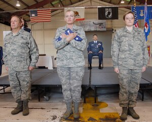 BEALE AIR FORCE BASE, Calif. -- Air Force Reservist Tech. Sgt.  Margaret O' Malley, 940th Air Refueling Wing Services Flight, holds the American Flag as it is passed through the ranks for 940th ARW Command Chief Hilton "Anthony" Armstrong at his retirement ceremony Sept. 14, 2008.  Also during the ceremony, Chief Master Sgt. Jason B. Henderson assumed the 940th ARW Command Chief position. (U.S. Air Force Photo/ Staff Sgt Luke Johnson)