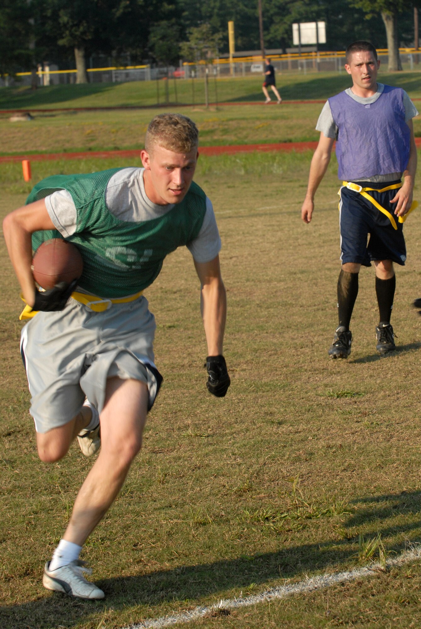 Airman 1st Class Josh Pittman, 41st Airlift Squadron,  takes of running from Senior Airman Roger Anderson, 314th Maintenance Squadron avionics technician,  during a flag football game on LRAFB in Sep. 23, 2008. The 41st Airlift Squadron won against the 314th Logistic Readiness Squadron, 20 against 9. (U. S. Air Force photo by Airman 1st Class Jim Araos)
