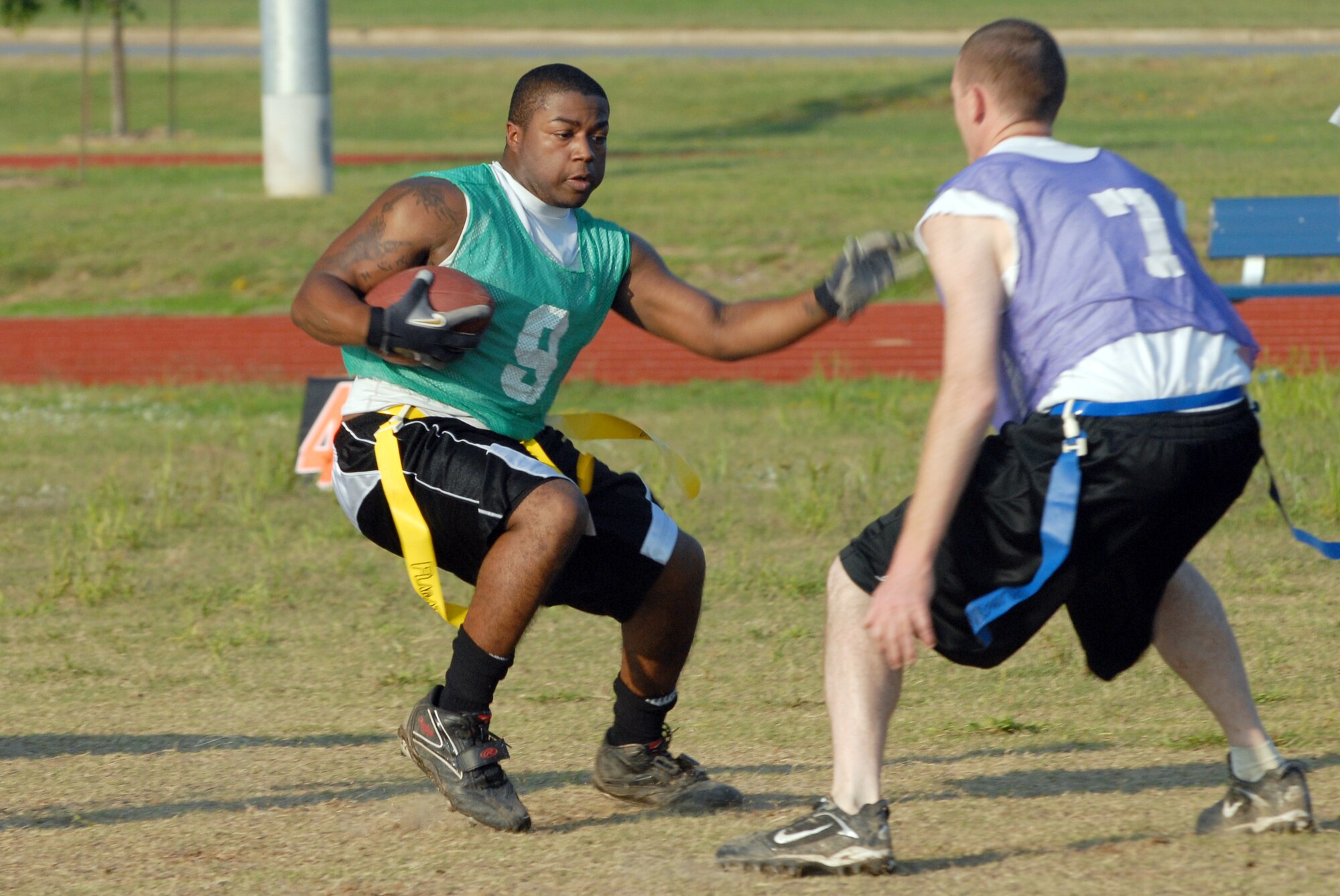 Airman 1st Class Brandon Abercrombie, 463rd Operation Support Squadron crew chief, evades Staff Sgt. Jeffrey Byrd, 314th Logistic Readiness Squadron Squadron vehicle dispatcher, during a flag football game on Little Rock AFB Sept. 23. The 463rd Airlift Group defeated defeated the 314th Logistic Readiness Squadron, 20 to 9. (U.S. Air Force photo by Airman 1st Class Jim Araos)