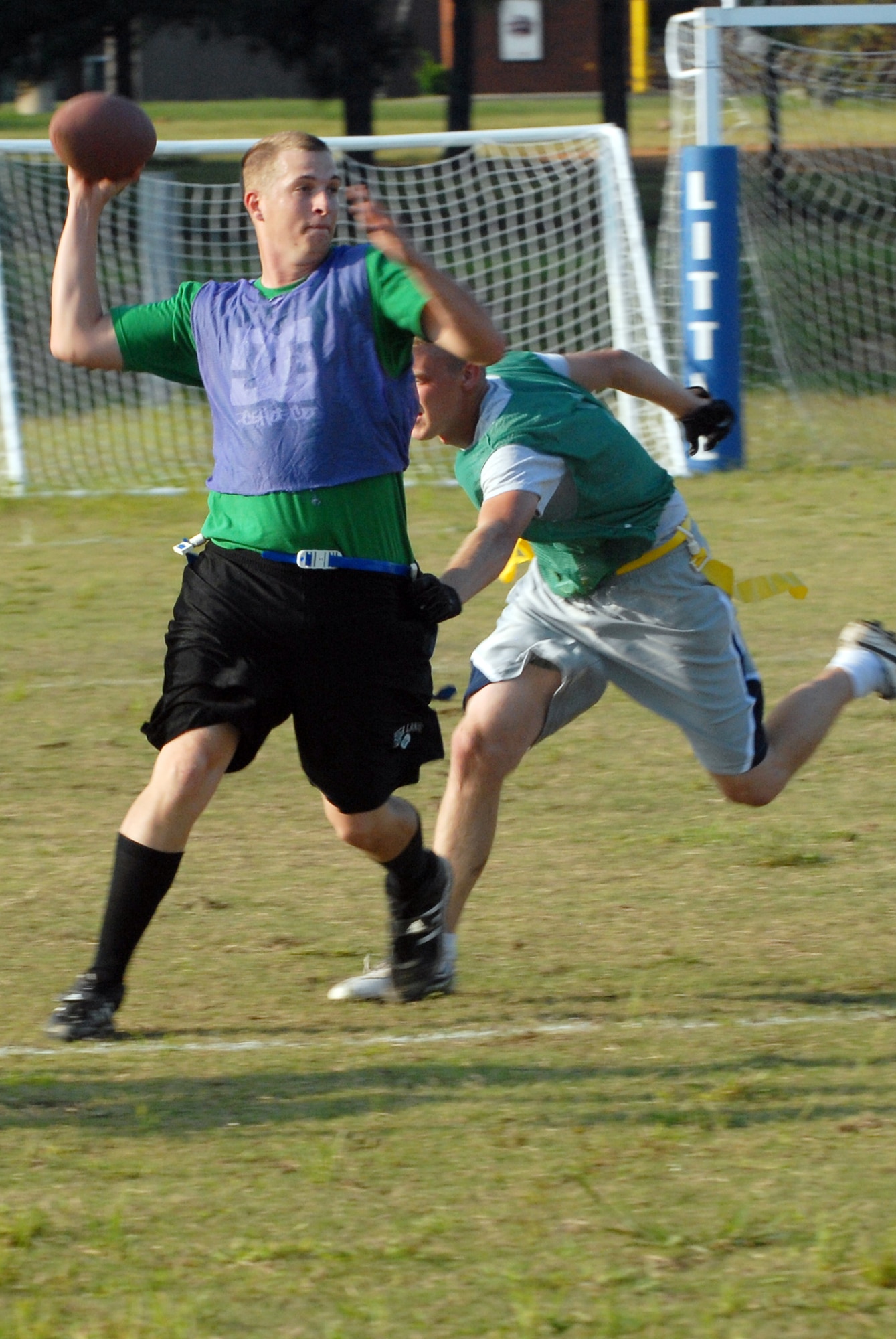 Airman 1st Class John Pittman, 50th Airlift Squadron, sacks the opposing
quarterback, Airman 1st Class Bryan Wails, 314th Logistic Readiness
Squadron, during a flag football game on Little Rock AFB Sept. 23. (U.S. Air Force photo by Airman 1st Class Jim Araos)
