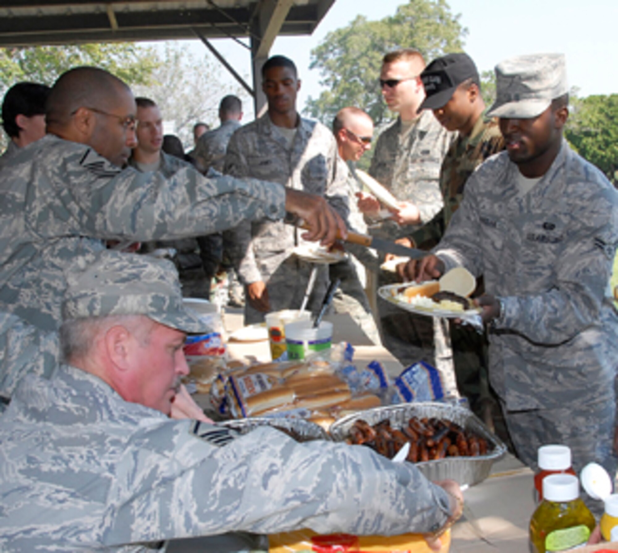 Sheppard’s First Sergeants serve food to the base’s Honor Guardsmen at an appreciation picnic Sept. 25 at the Hospital Pavilion. According to the U.S. Air Force Honor Guard website, www.honorguard.af.mil, “the ceremonial guardsmen is an individual of good reputation, having integrity, ethical conduct and exhibiting standards which merit respect; responsible for protecting and overseeing the maintenance of standards on and off duty.” (U.S. Air Force photo/Mike Litteken)  