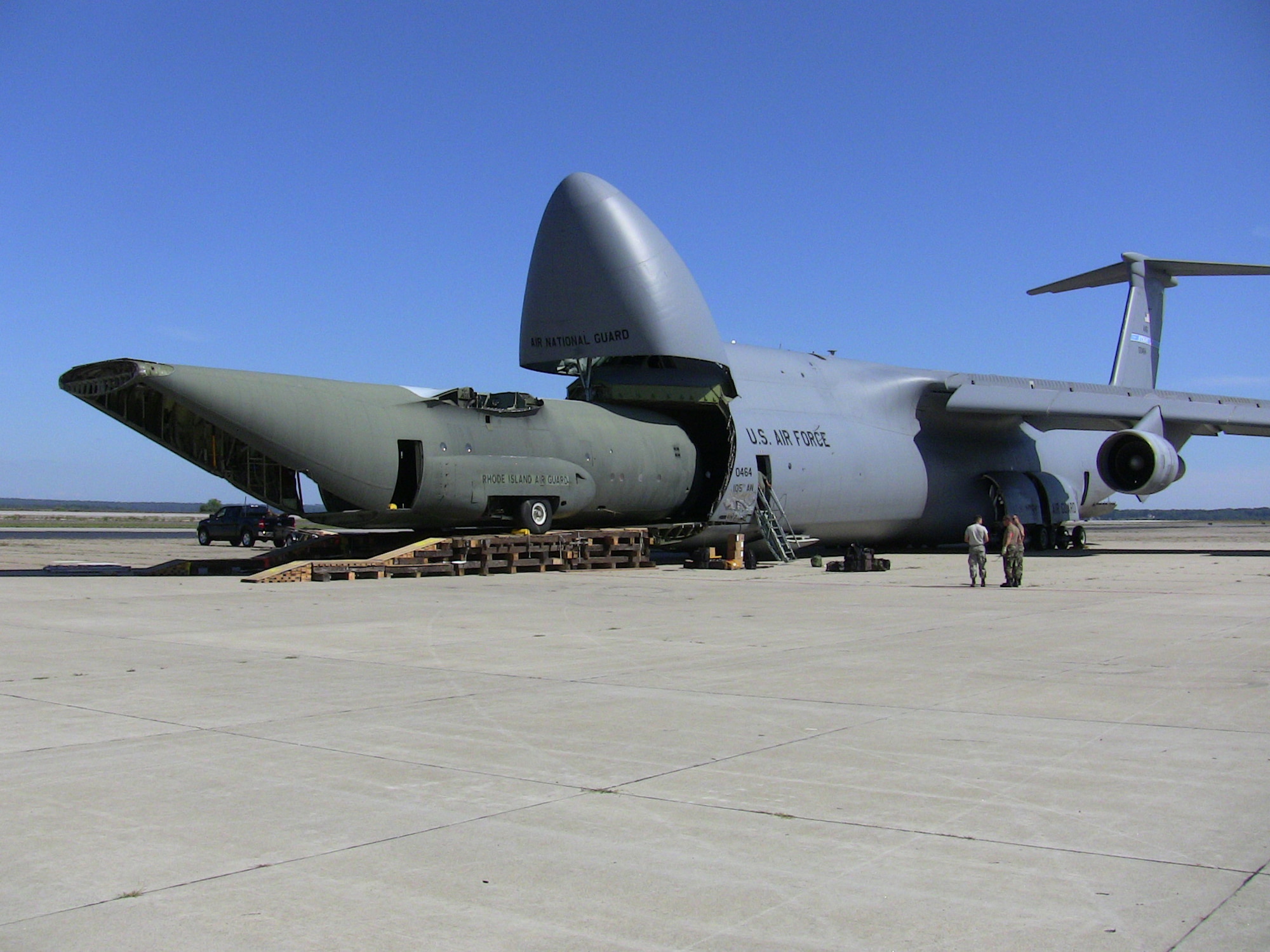 QUONSET POINT, R.I. -- A C-130 training fuselage is loaded onto a C-5 for transport to Stratton Air National Guard Base, N.Y. The New York unit will use the aircraft for training purposes. This was the first time a C-5 transported a C-130 fuselage.