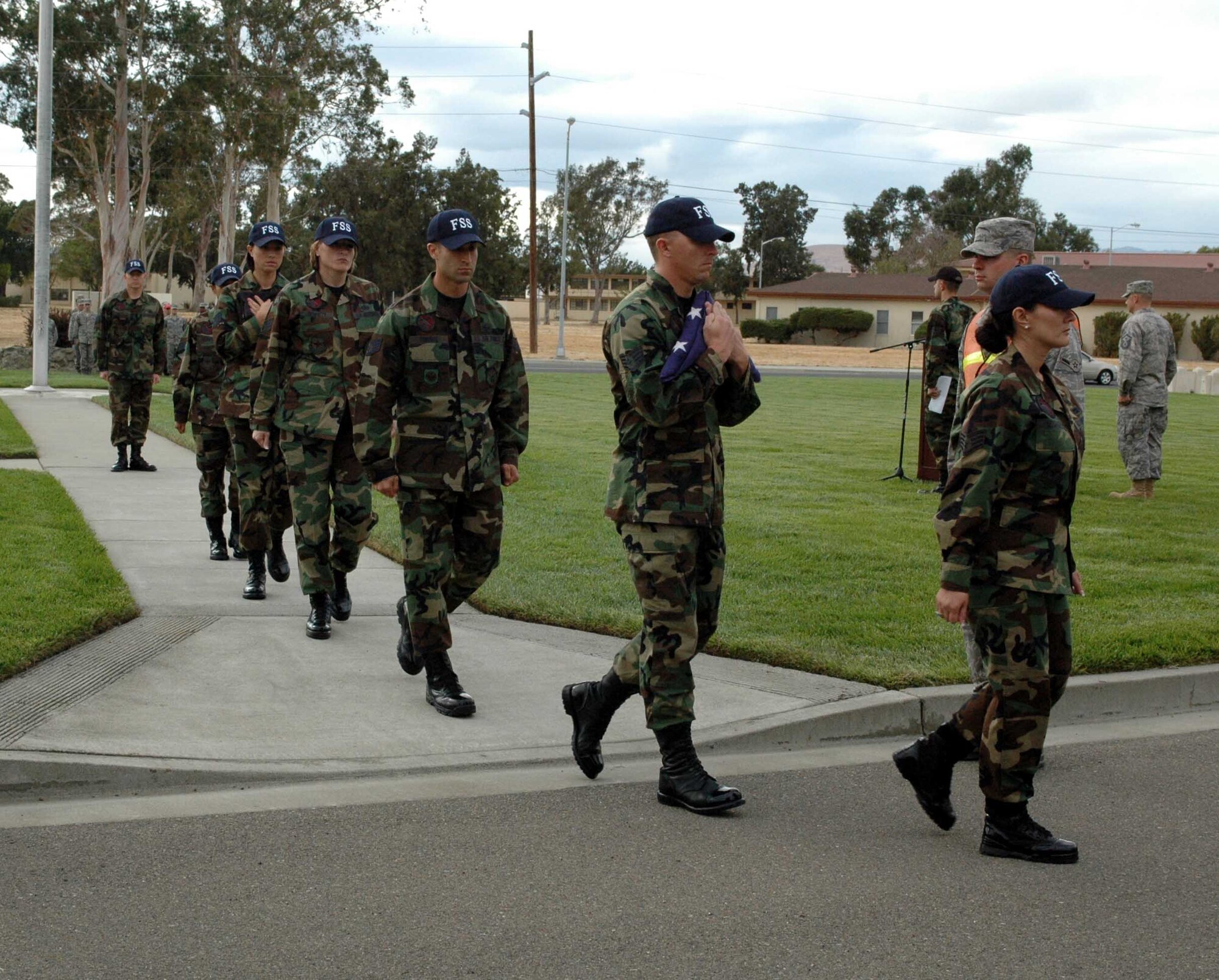 Instructors from the Sgt. Paul P. Ramoneda Airman Leadership School carry the American and Prisoner(s) of War/Missing in Action flags after the POW/MIA Remembrance vigil Sept. 19. (U.S. Air Force photo/Airman 1st Class Kristen Rohrer)

