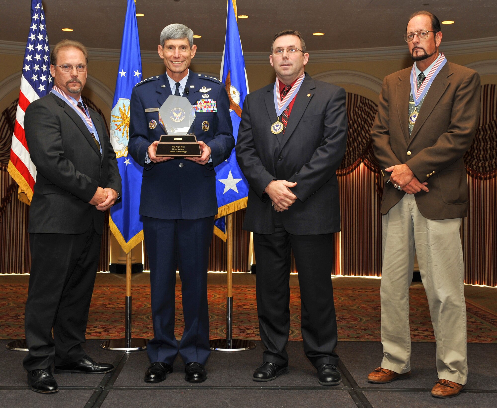The 982nd Maintenance Squadron's Deep Purple team accept their 2008 Chief of Staff Team Excellence Award Sept. 15 from Air Force Chief of Staff Gen. Norton A. Schwartz, second from left, during the Air Force Association Air & Space Conference and Technology Expo in Washington, D.C. The team was one of five selected for the annual award. Team members include Randall Campbell, left, Mitch Weatherly and Carl Cummings. (U.S. Air Force photo/Michael Pausic)
