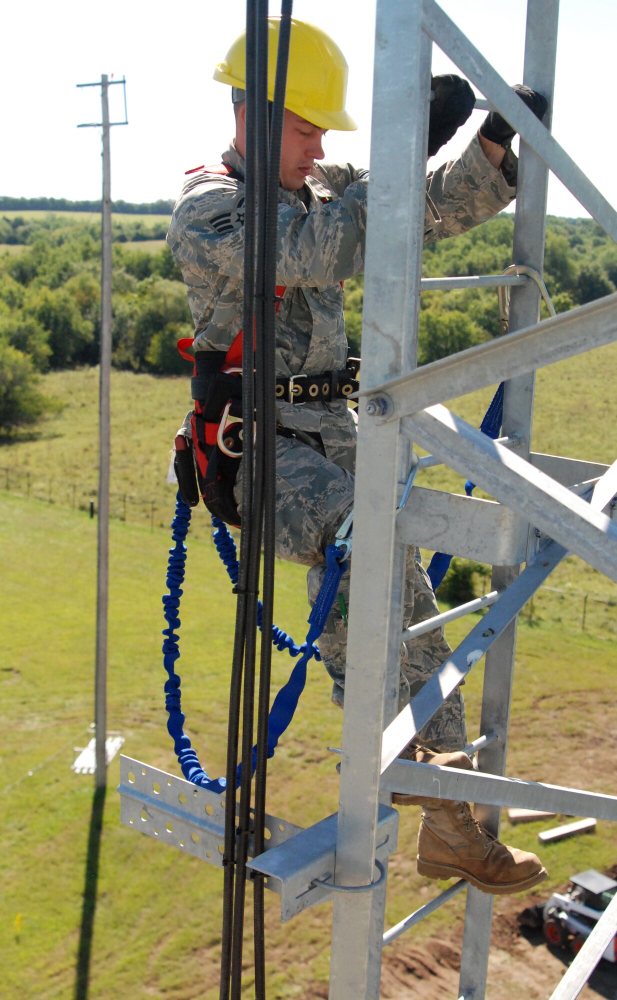 MCCONNELL AIR FORCE BASE, Kan. -- Senior Airman Josh Nieson, Air National Guardman from 210th Engineer Installation Squadron,  Minnapolis, Minn., steps down a guide ladder, 70 feet high, on the new ground to air transmit receiver tower, Sept. 18.  The two towers will help provide radio communication between the air traffic control Airmen and command and control personnel to flying aircraft. (photo by Airman 1st Class Jessica Lockoski)