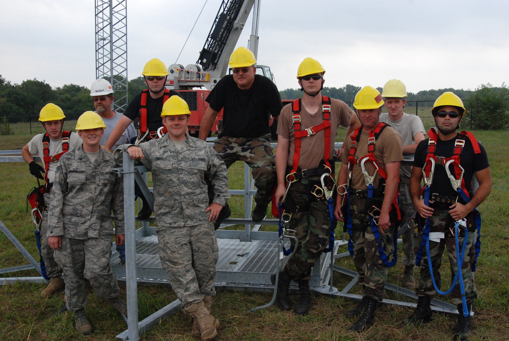 MCCONNELL AIR FORCE BASE, Kan. -- Members from the 22nd Civil Engineer Squadron, Communications Squadron and Guardsman from the 210th Engineer Installation Squadron, Minneapolis, Minn.  install two, 70-foot ground to air transmit receiver towers during a month long project in September. (photo by Airman 1st Class Jessica Lockoski)