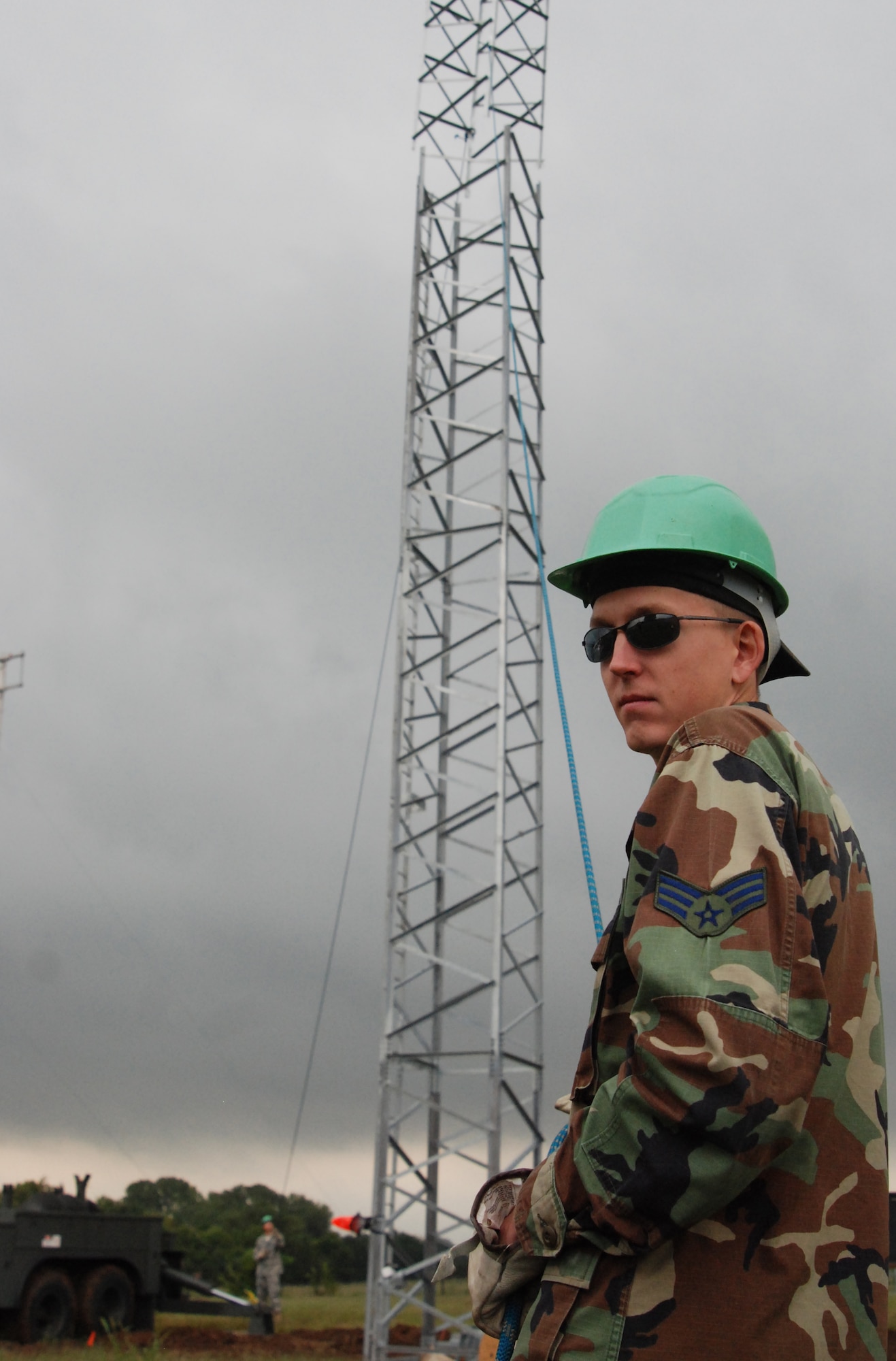 MCCONNELL AIR FORCE BASE, Kan. -- Senior Airman Dustin Alexander, 22nd Communications Squadron, holds a linerope to maneuver a piece metal tower structure onto the ground to air transmit receiver tower, Sept. 8.  (photo by Airman 1st Class Jessica Lockoski)