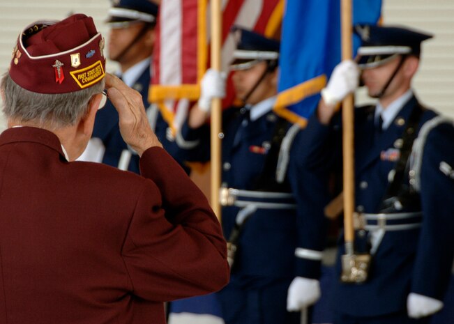 Charles Murray, salutes the U.S. flag while the base honor guard posts the colors during retreat in nose dock two Sept. 24. Charleston AFB commemorated their brothers in arms who had become prisoners of war or were declared missing in action during a time of war. Mr. Murray is a former prisoner of war. (U.S. Air Force photo/Airman 1st Class Timothy Taylor)