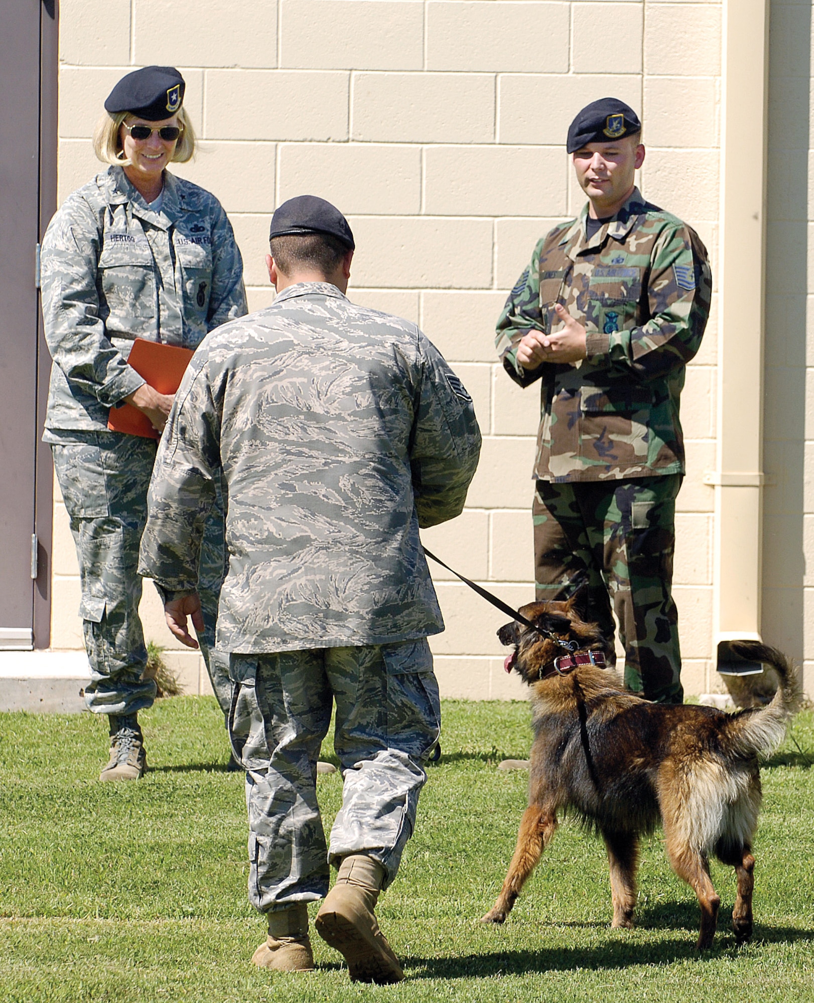 During her visit to Tinker, director of Security Forces, Brig. Gen. Mary Hertog, stopped by the military working dogs and toured other areas of the “coplex.” (Air Force photo/Margo Wright)