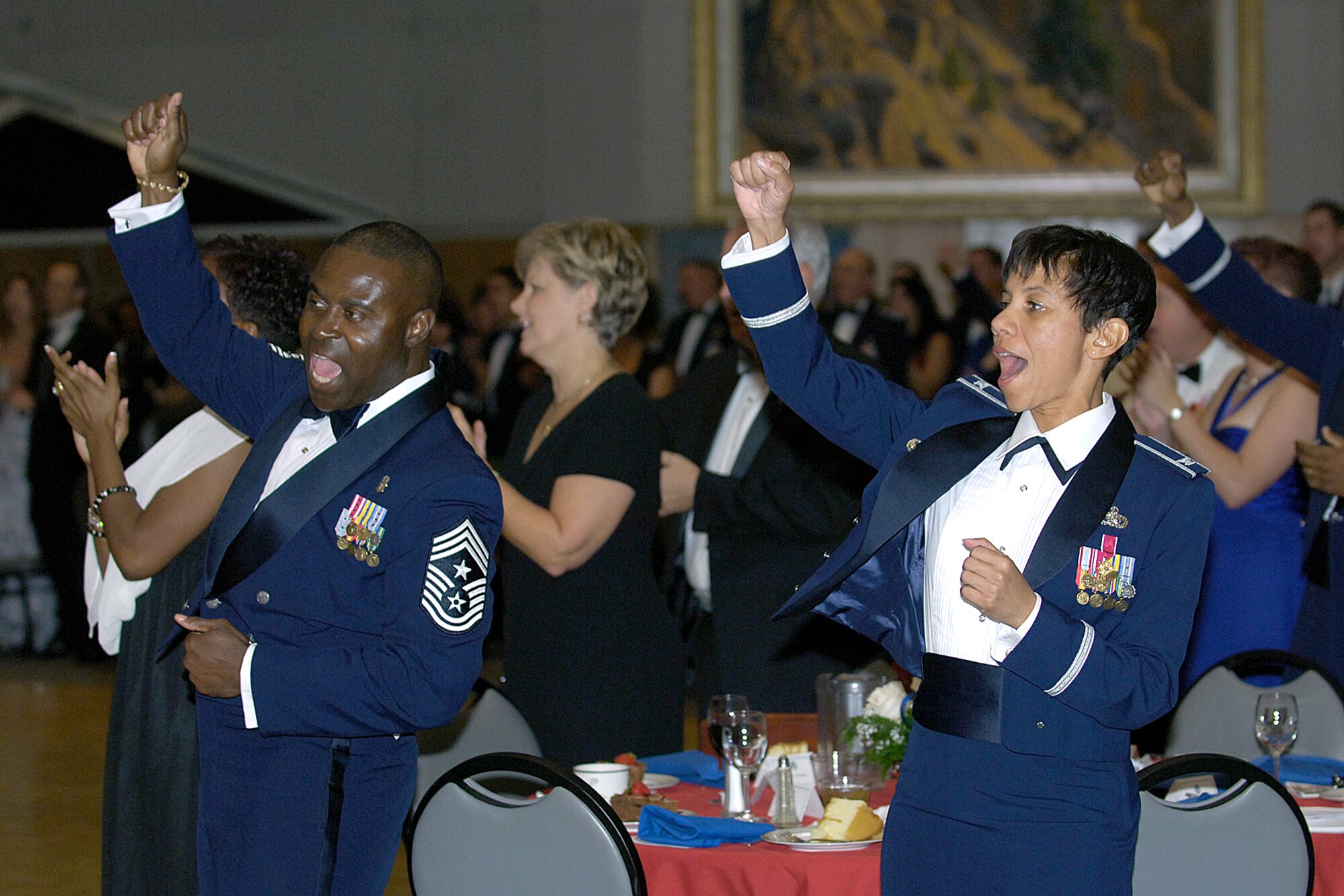 72nd Air Base Wing Command Chief Master Sgt. Eric Harmon and Col. Mona Lisa Tucker, vice wing commander, join in a cheer at the Air Force Ball Sept. 19 at the National Cowboy and Western Heritage Museum in Oklahoma City. The ball celebrated the Air Force’s 61st birthday. Former Oklahoma Air Logistics Center executive director, Garry Richey, was the guest speaker. (Air Force photo/Margo Wright)