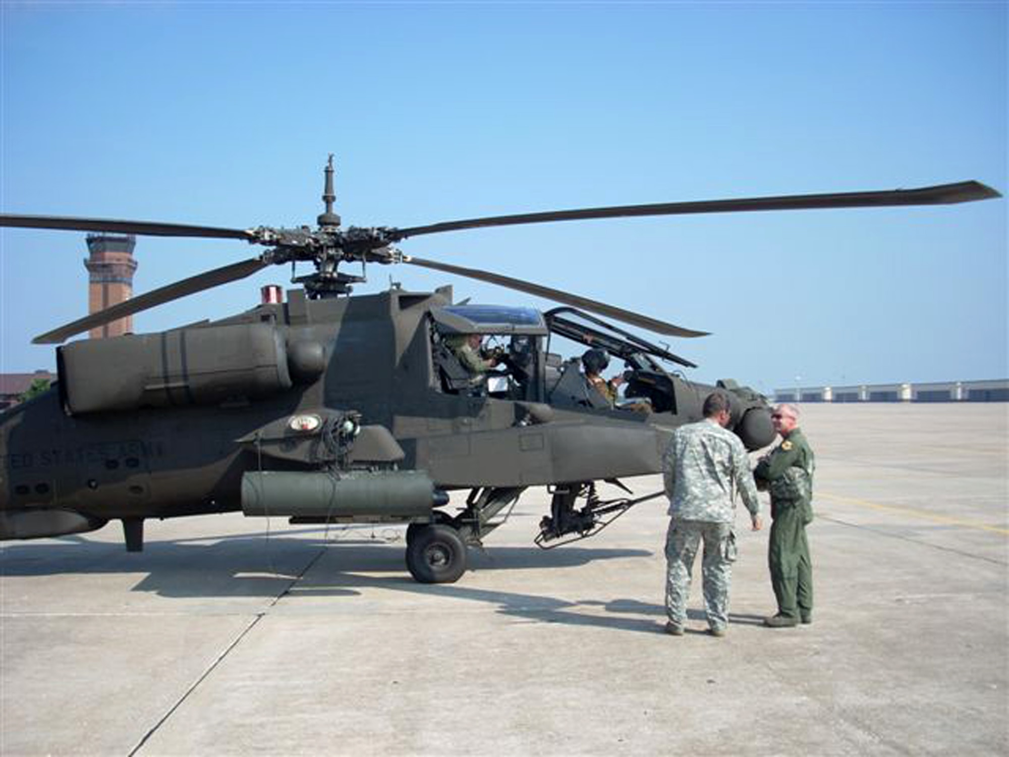 WHITEMAN AIR FORCE BASE, Mo. – Army Lt. Col. Thomas Burson, 1-135th Attack Battalion, and Brig. Gen. Garrett Harencak, 509th Bomb Wing commander, prepare to take to the skies for more than an hour Sept. 22. The familiaritazation flight consisted of basic Army helicopter maneuvers. The AH-64A Apache from the 1-135th Attack Reconnaissance Battalion is part of the Missouri Army National Guard sharing Whiteman’s ramp. (Photo printed with permission of Army Capt. Ben Carter)

