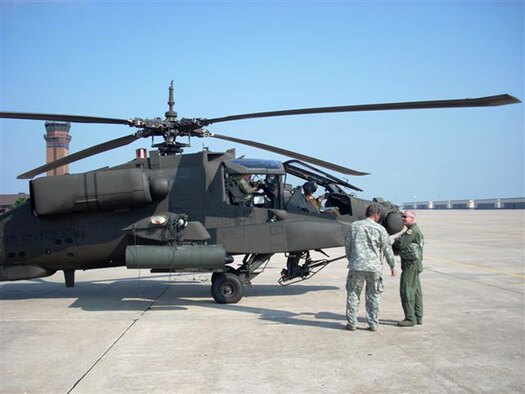 WHITEMAN AIR FORCE BASE, Mo. – Army Lt. Col. Thomas Burson, 1-135th Attack Battalion, and Brig. Gen. Garrett Harencak, 509th Bomb Wing commander, prepare to take to the skies for more than an hour Sept. 22. The familiaritazation flight consisted of basic Army helicopter maneuvers. The AH-64A Apache from the 1-135th Attack Reconnaissance Battalion is part of the Missouri Army National Guard sharing Whiteman’s ramp. (Photo printed with permission of Army Capt. Ben Carter)

