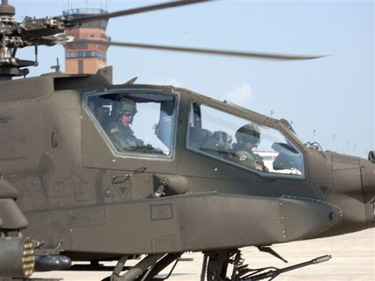 WHITEMAN AIR FORCE BASE, Mo. – Army Lt. Col. Thomas Burson, 1-135th Attack Battalion, and Brig. Gen. Garrett Harencak, 509th Bomb Wing commander, prepare to take to the skies for more than an hour Sept. 22. The familiaritazation flight consisted of basic Army helicopter maneuvers. The AH-64A Apache from the 1-135th Attack Reconnaissance Battalion is part of the Missouri Army National Guard sharing Whiteman’s ramp. (Photo printed with permission of Army Capt. Ben Carter)

