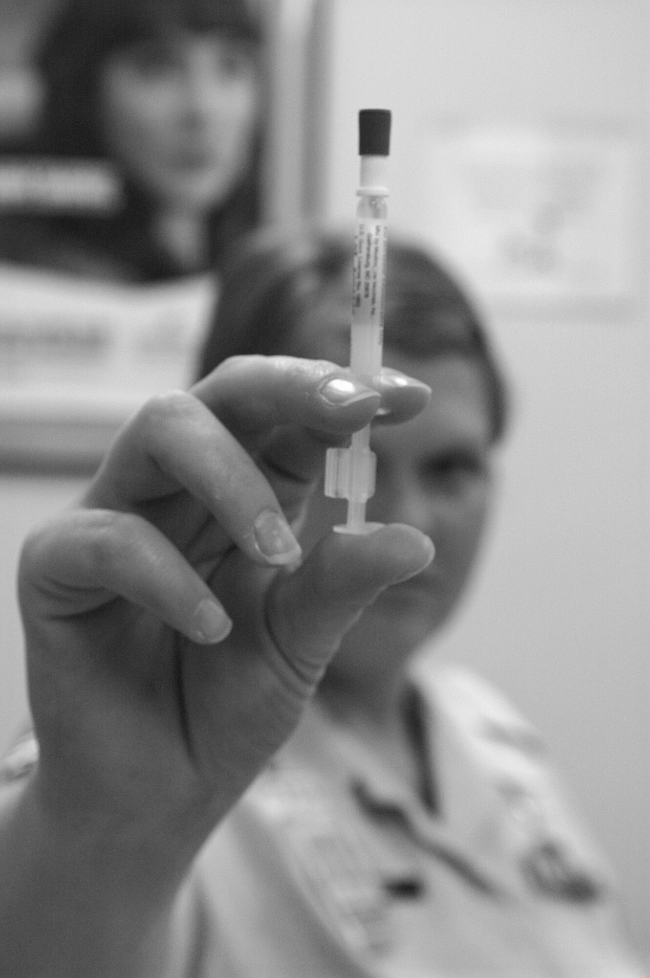 Senior Airman Denne Boykins, 72nd Medical Operations Squadron immunization services, holds up a live flu vaccine in the form of a nasal mist. The vaccine is currently available for active duty military members. The immunization clinic is open from 7:15 a.m. to 3:30 p.m. A flu shot drive-through for active duty members under age 50 will be held from 6 to 7:30 a.m. next Monday through Friday in the dorm parking lot on Arnold Street, across from the Medical Group. Immunization services can schedule to come out to units with 200 or more members. The vaccine will be made available to dependents and retirees at a later date, which will be published in the Tinker Take Off. (Air Force photo/Micah Garbarino)