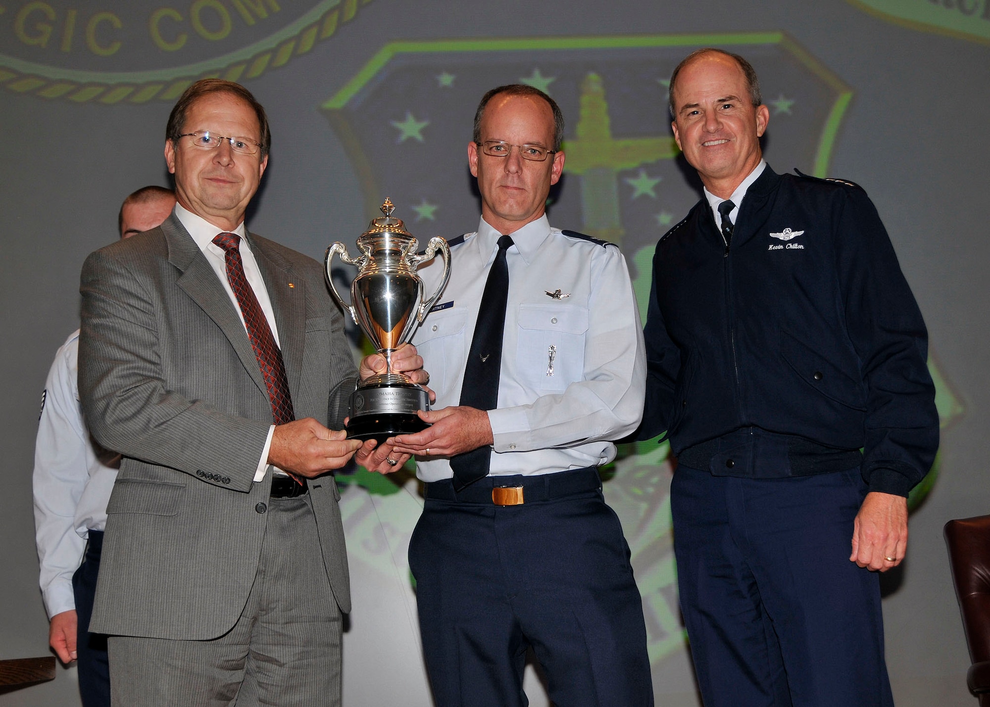 Col. Michael Fortney, 341st Missile Wing commander (center), receives the Omaha Trophy from Gen. Kevin Chilton, U.S. Strategic Command commander (right), and Mr. John Whisler, USSTRATCOM Consultation Committee representative (left), Sept. 18 at Malmstrom Air Force Base, Mont. The trophy is awarded to a unit who demonstrates the highest standards of performance, and the selection for the award is based on meritorious achievements, safety, community involvement and humanitarian actions. (U.S. Air Force photo/John Turner)