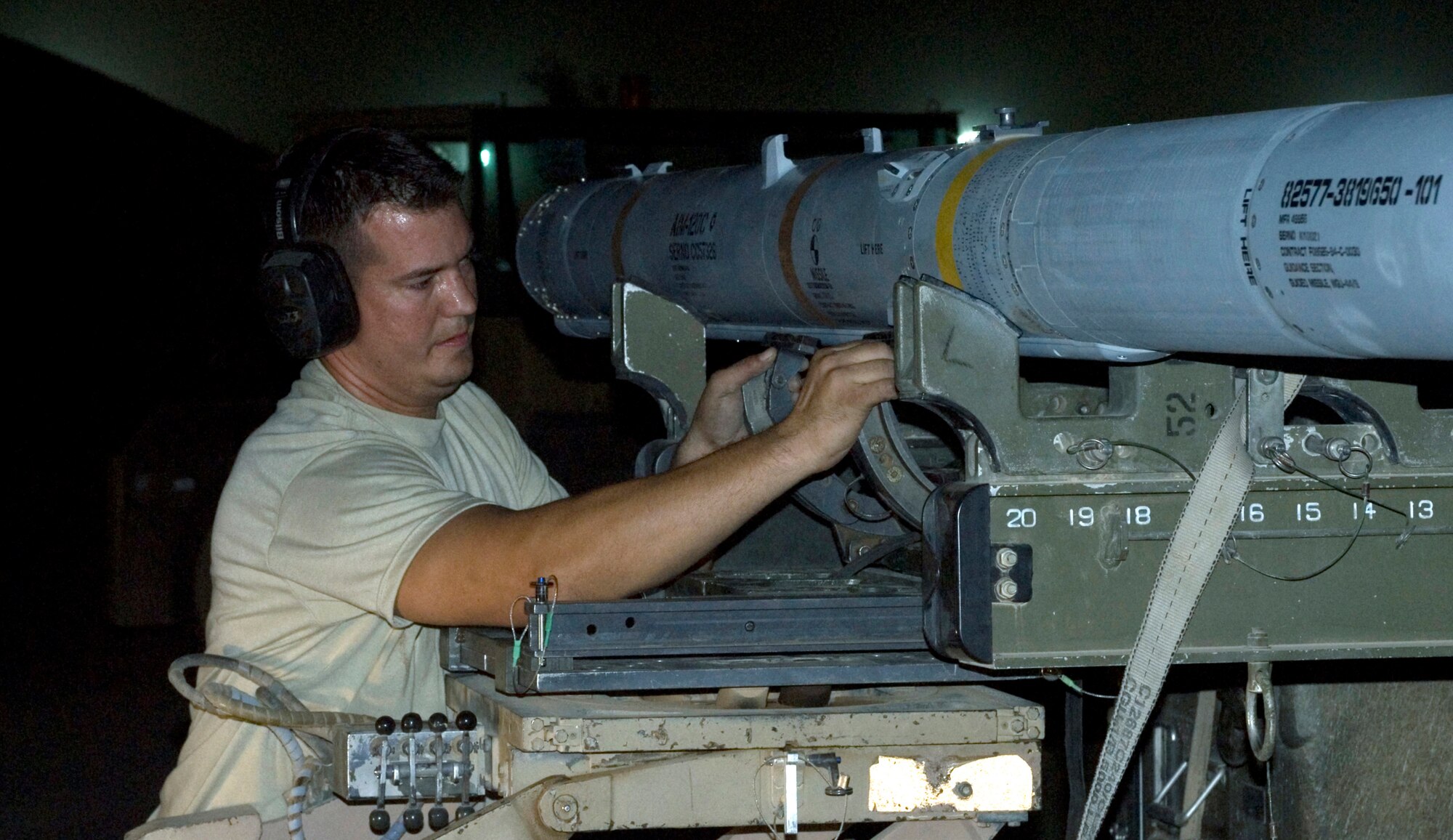 Staff Sgt Matthew Edwards secures an AIM-120C air-to-air missile onto a bomb lift truck after removing it from an F-16 Fighting Falcon at Joint Base Balad, Iraq, Sept. 22. Boom, a weapons load crewmember with the 332nd Expeditionary Aircraft Maintenance Squadron here, is deployed from the Oklahoma Air National Guard's 138th Fighter Wing. His hometown is Owasso, Okla. (U.S. Air Force photo/Tech. Sgt. Erik Gudmundson)