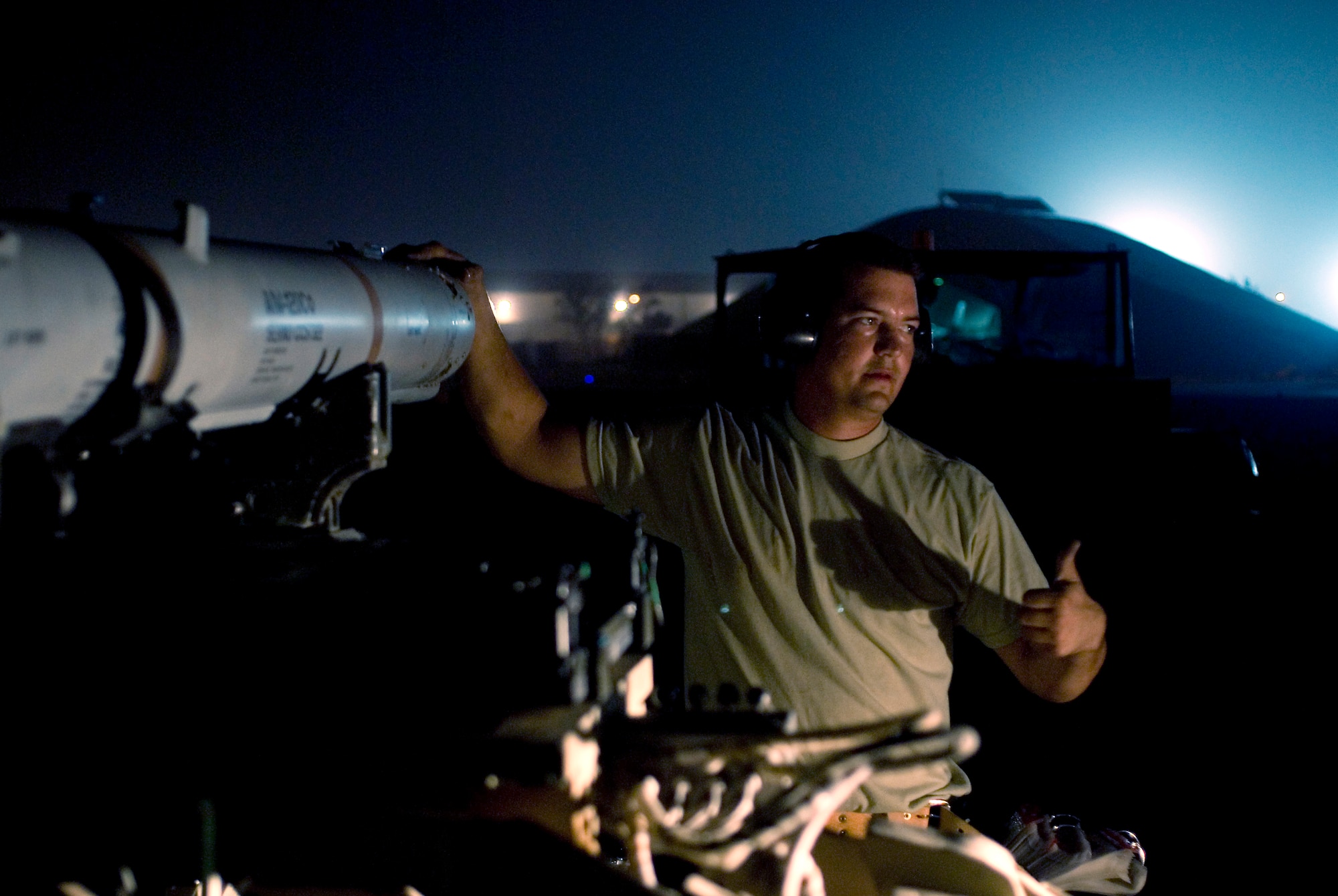 Staff Sgt Matthew Edwards directs a bomb lift truck into position to load an AIM-120C air-to-air missile after removing it from an F-16 Fighting Falcon at Joint Base Balad, Iraq, Sept. 22. Edwards, a weapons load crewmember with the 332nd Expeditionary Aircraft Maintenance Squadron, is deployed from the Oklahoma Air National Guard's 138th Fighter Wing. His home town is Owasso, Okla. (U.S. Air Force photo/Tech. Sgt. Erik Gudmundson)