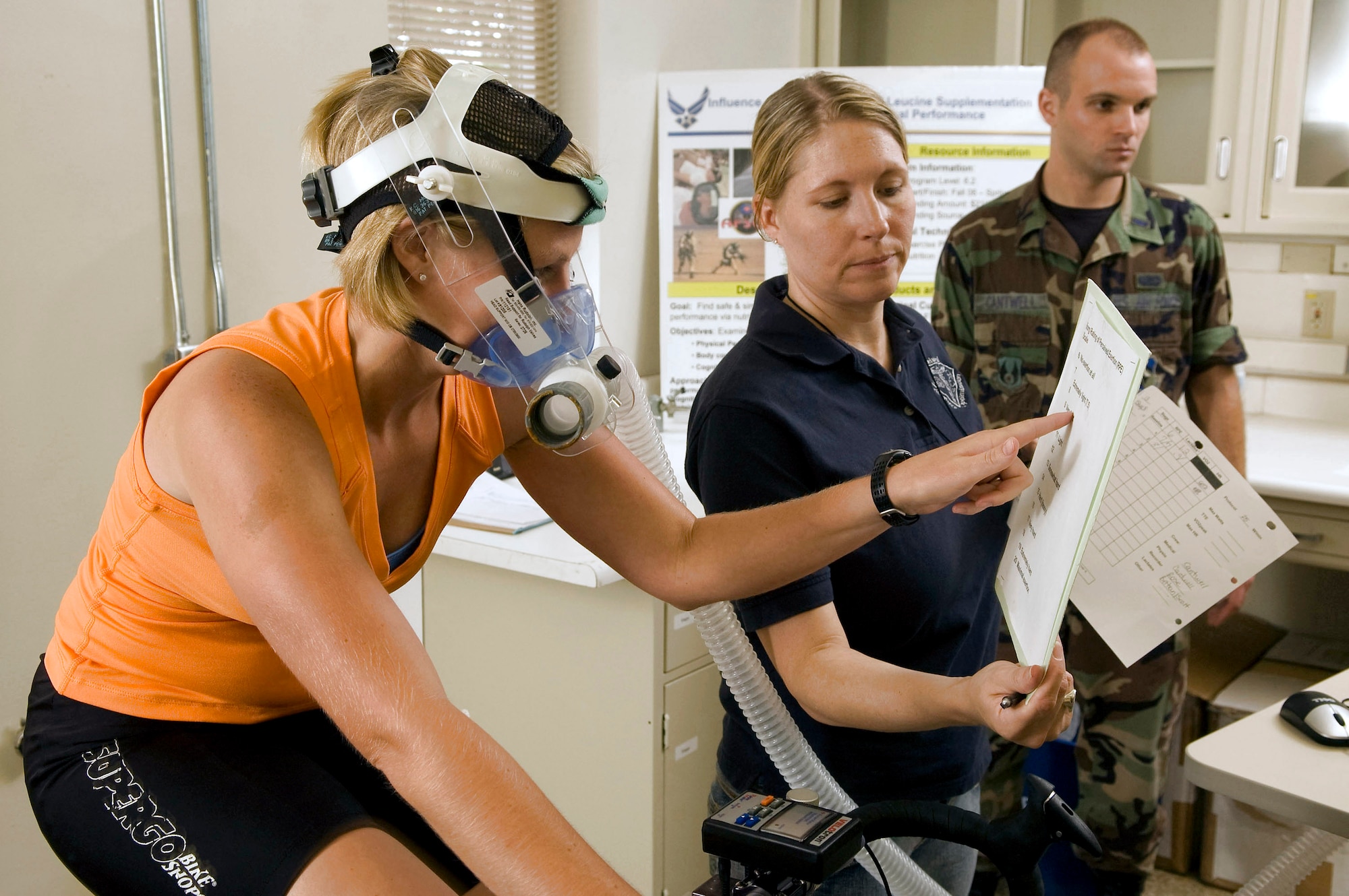 Kassi Micak participates in the citrulline malate study conducted by Air Force Research Laboratory officials Aug. 19 at Brooks City-Base, Texas. Her perceived level of exertion is evaluated while Tech. Sgt. Darci Rose, an aerospace physiology technician, records exertion, lactates, VO2 max and heart rate during the study. Ms. Micak, a competitive cyclist based in San Antonio, volunteered for the study. (U.S. Air Force photo/Steve Thurow) 
