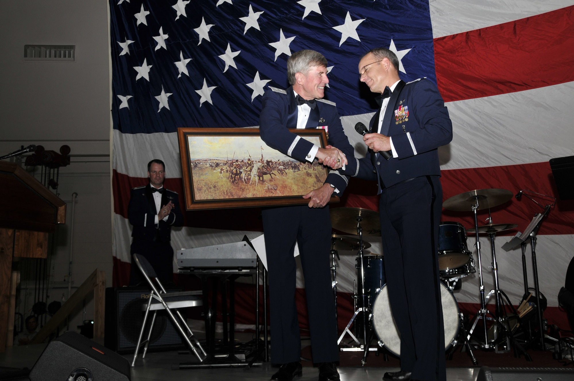Col. Michael Fortney, 341st Missile Wing commander, presents Maj. Gen. (Ret.) Timothy McMahon, former 341st Missile Wing commander and guest speaker for the Air Force Ball, with a painting as a thank-you gift after his speech. (U.S. Air Force photo/John Turner)