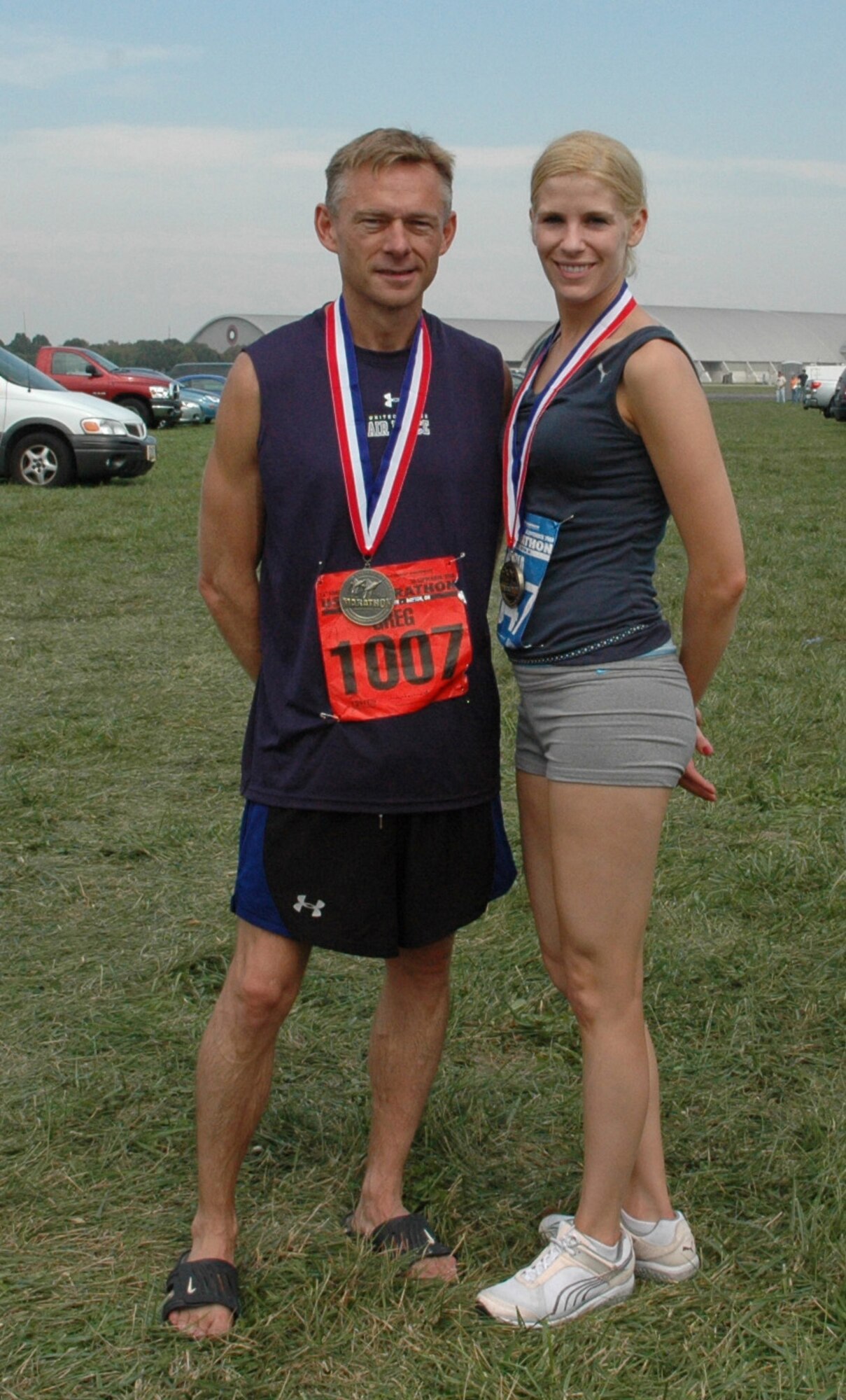 WRIGHT PATTERSON AIR FORCE BASE, Ohio -- Senior Airman Andria J. Allmond, 512th Airlift Wing Public Affairs, participated in the half-marathon portion of Air Force Marathon activities Sept. 18 to 20 at Wright Patterson Air Force Base, Ohio. She finished the 13.1 miles with a time of 1 hour and 44 minutes, ranking her at 229th out of about 2,500 competitors and 8th in her age group of 25 to 29. Pictured with her following the run is Chief Master Sgt. Gregory W. Koenig, from Hill Air Force Base, Utah, who inspired Airman Allmond to participate in the event and mentored her during the training phase. He ran the full marathon in 3 hours, 42 minutes. (U.S. Air Force courtesy photo)