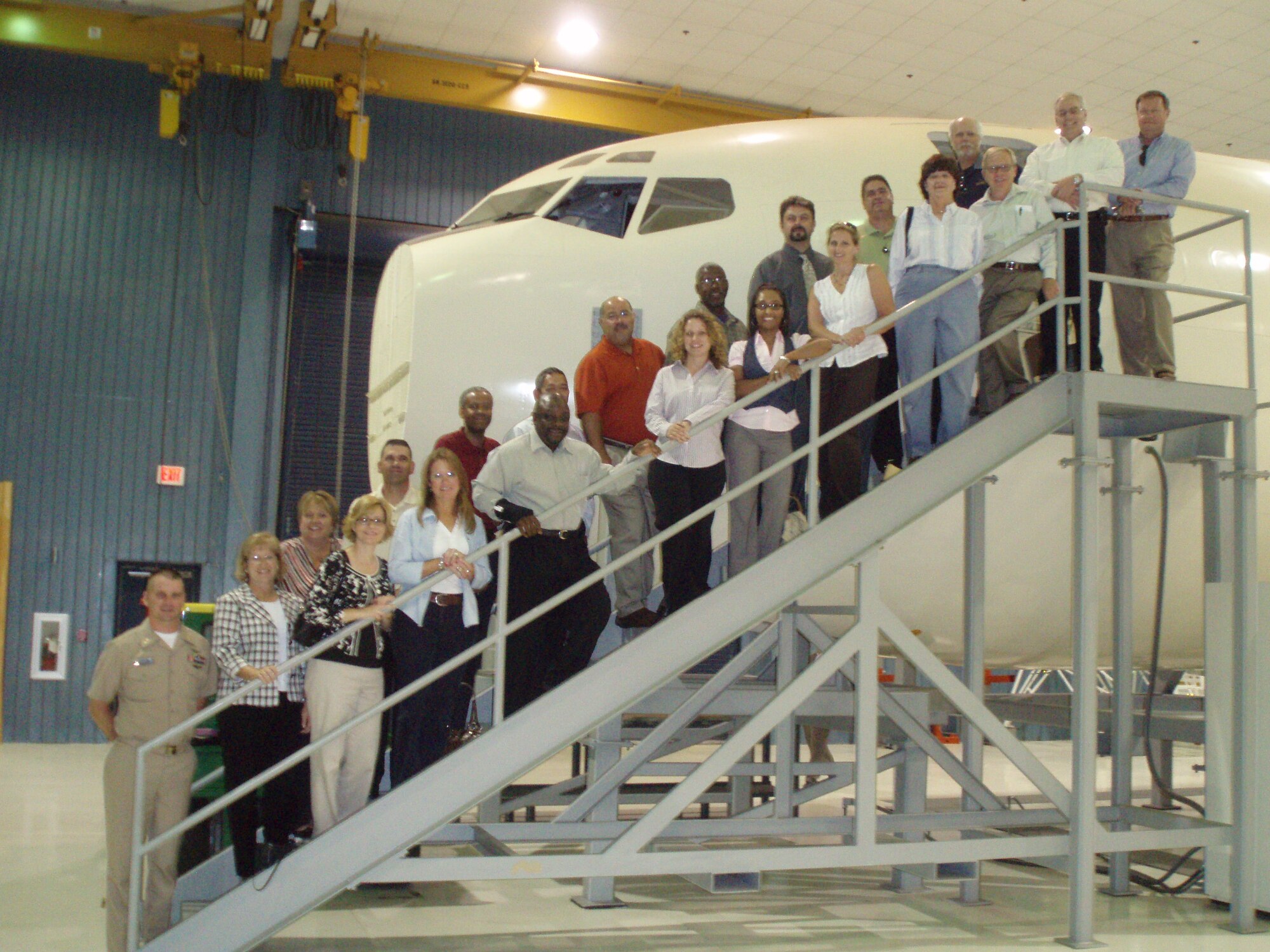 CLDP participants and hosts stand next to a Navy E-6B training fuselage.  Top row from left: Joan Gudinas; CLDP participants Lincoln Nealy, Bill Brewer, Vincente Javier, Eduardo Garcia, Carl Dean, Roger Drinnon, Lou Lombardi, and Mark Morgan.  Front row:  Aviation Electronic Technician Chief Petty Officer Jeffrey Forbes; AMC employee development specialist Mary Murphy; CLDP participants Gina Claghorn, Pamela Bragg, Frazier Simmons, Kathy Gunn, Tanya Wilson, Lori Anderson, Jan Howard, and Patrick Nevitt; Gregg Clark and Tinker Employee Enhancement Program manager Tim Collins.  (U.S. Air Force Photo)